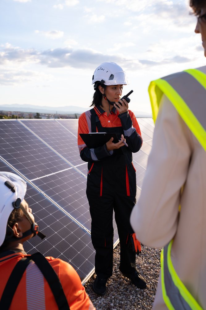 Technician inspecting solar panels on a rooftop in Madrid, Spain