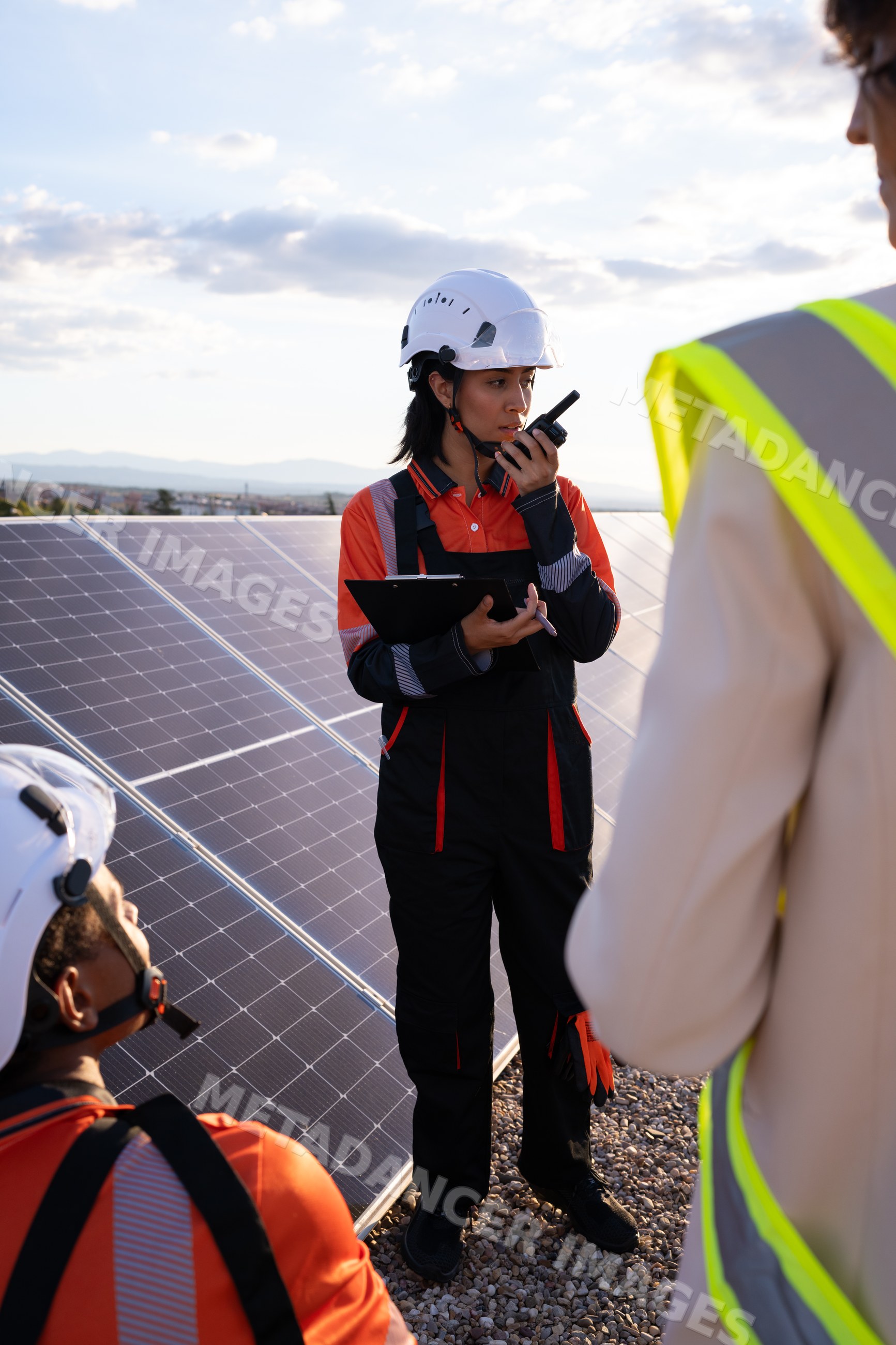 Technician inspecting solar panels on a rooftop in Madrid, Spain