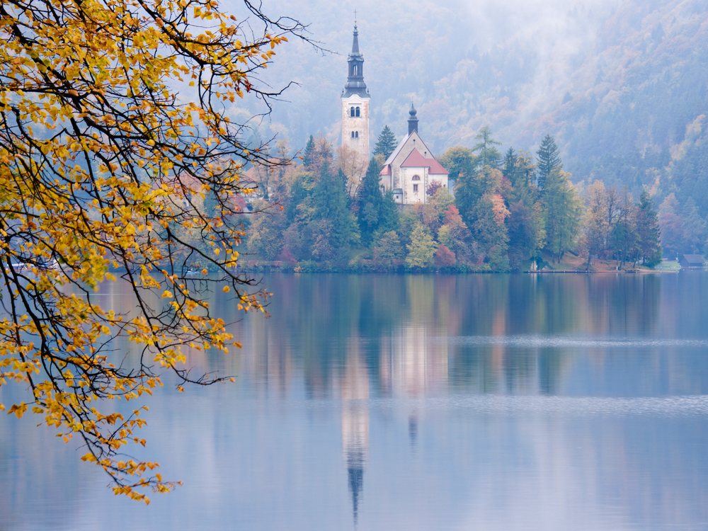 Church of assumption on an island reflected in autumn water