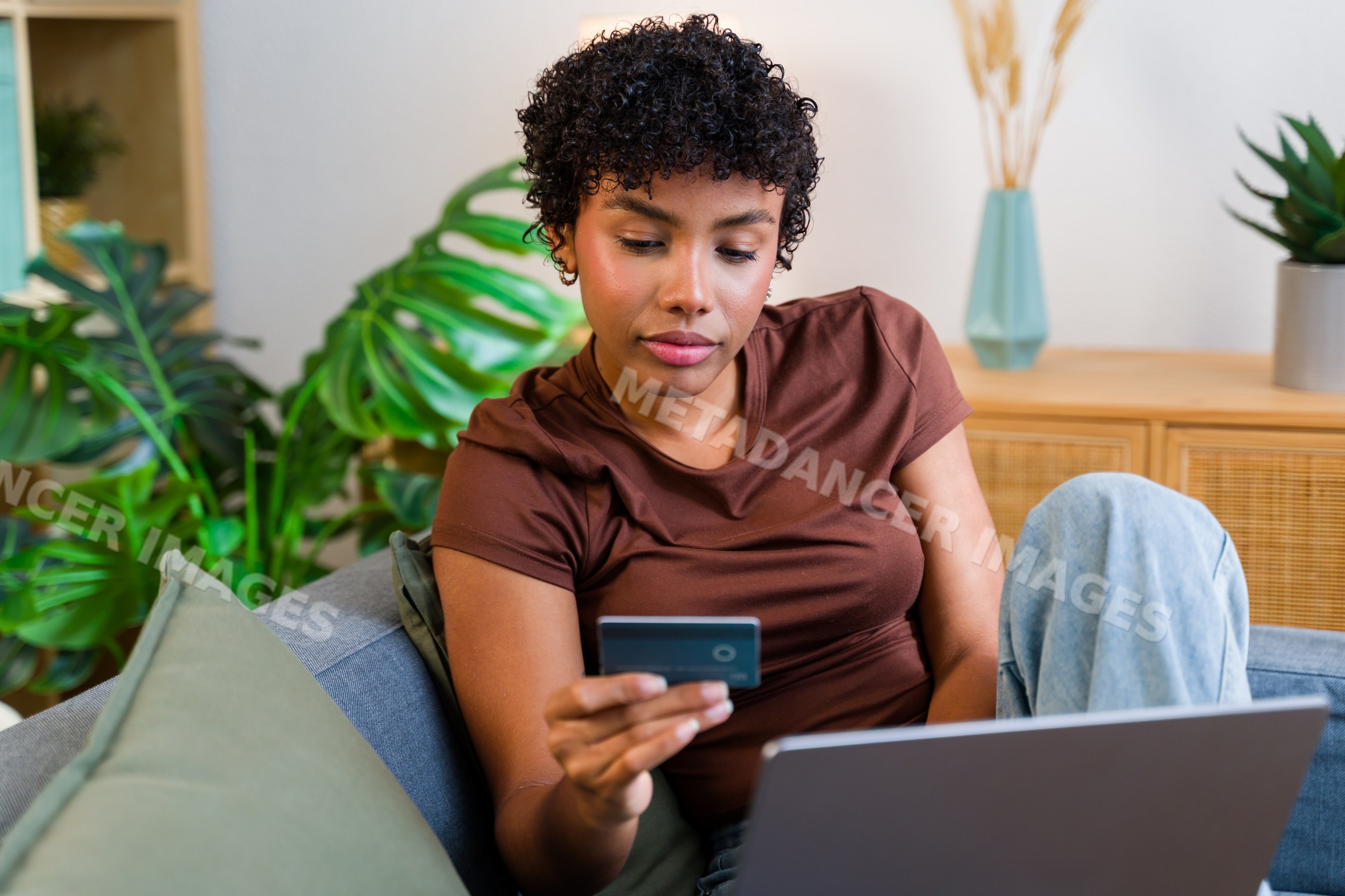 African American woman making online shopping payment with credit card