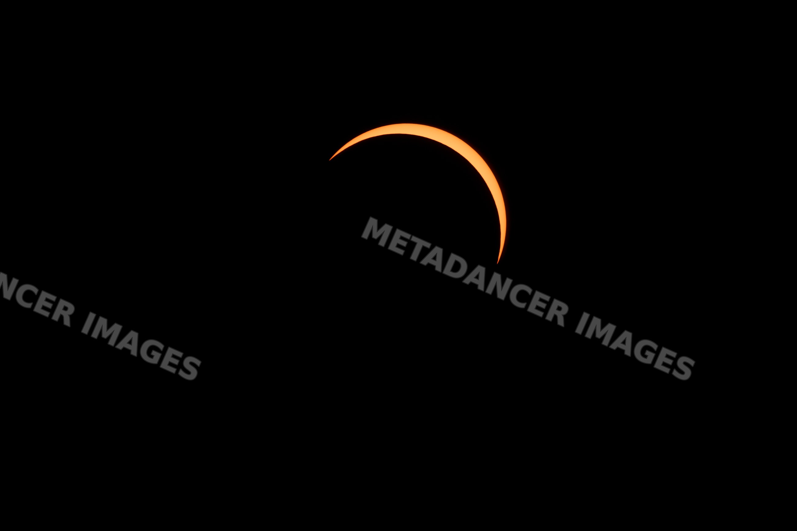 Solar eclipse showing crescent moon silhouetted against the sun