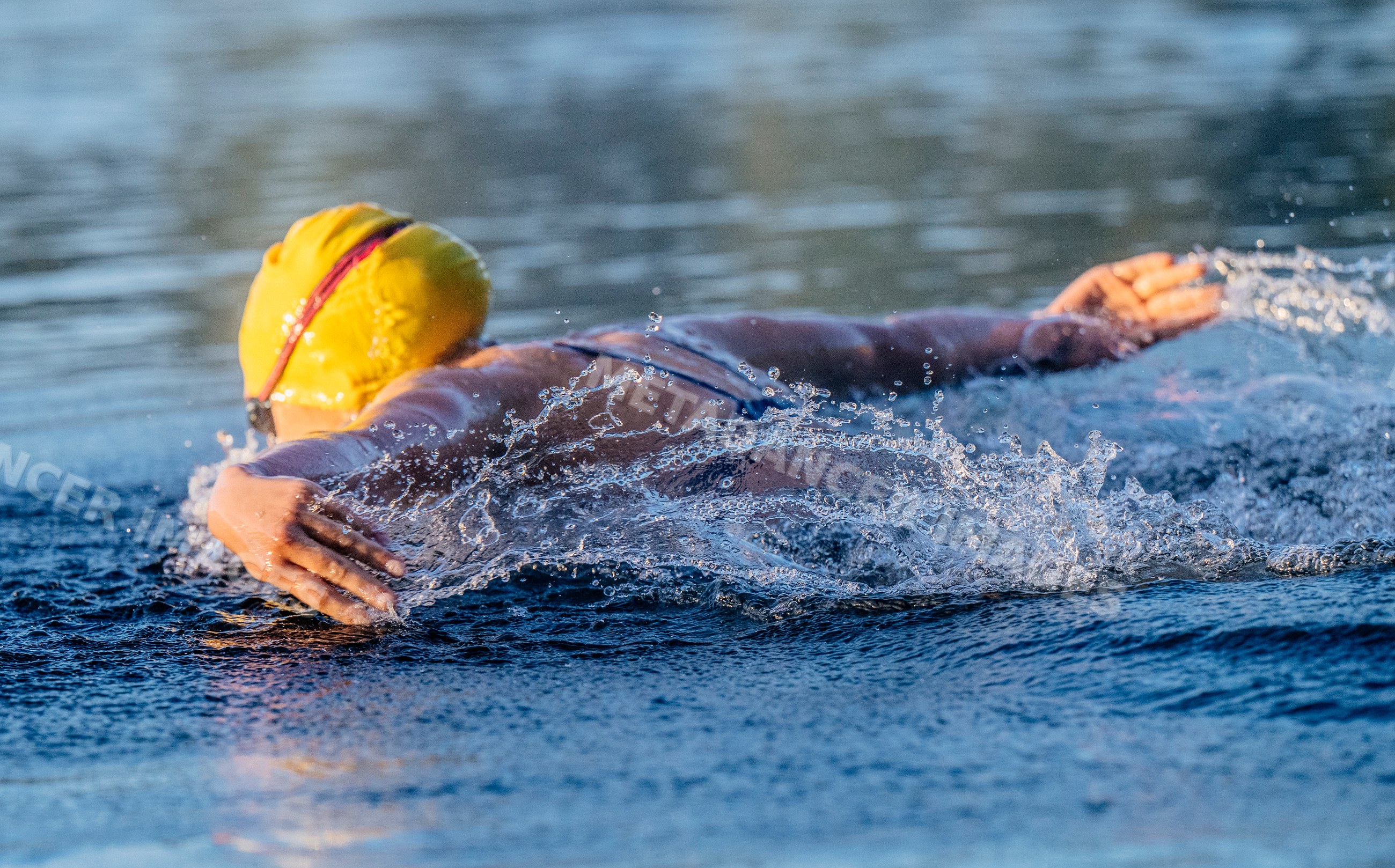 White swimmer performing stroke in open water