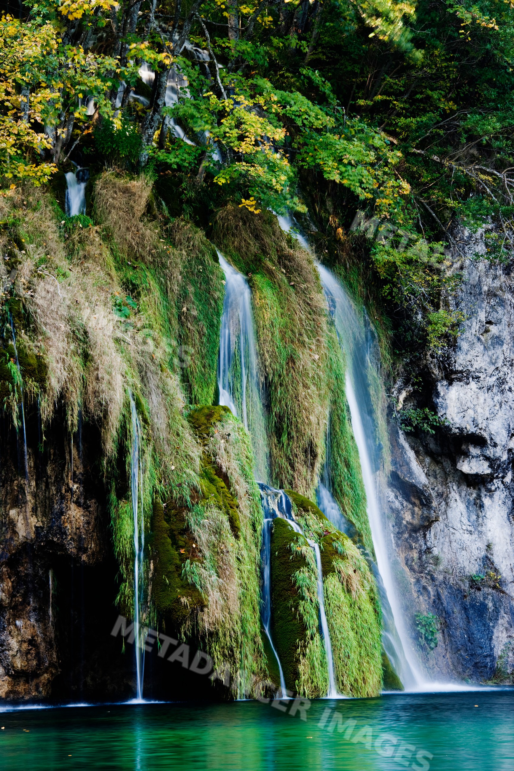 Waterfall cascading over mossy rocks, croatia