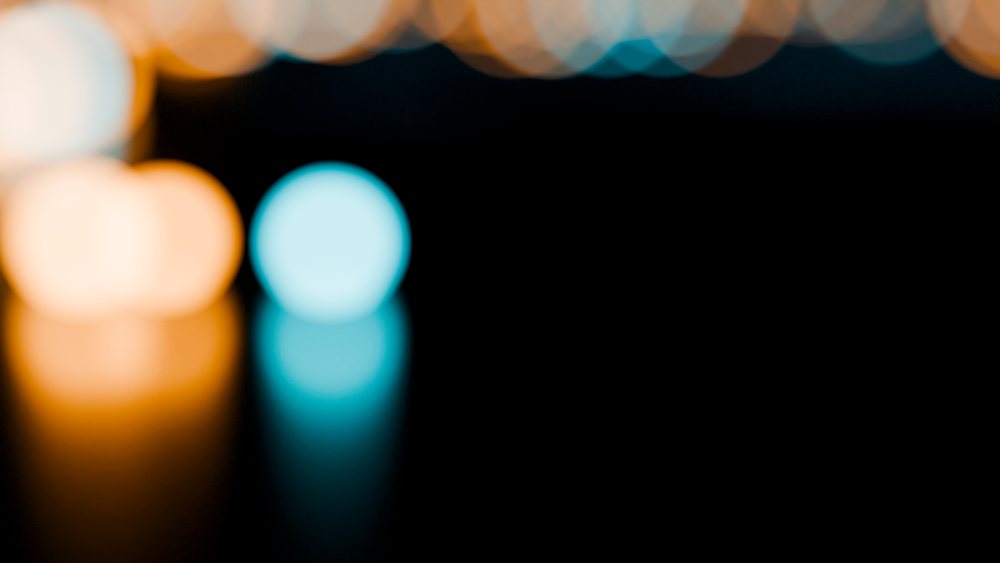 Colorful blurred lights with bokeh effect on dark background