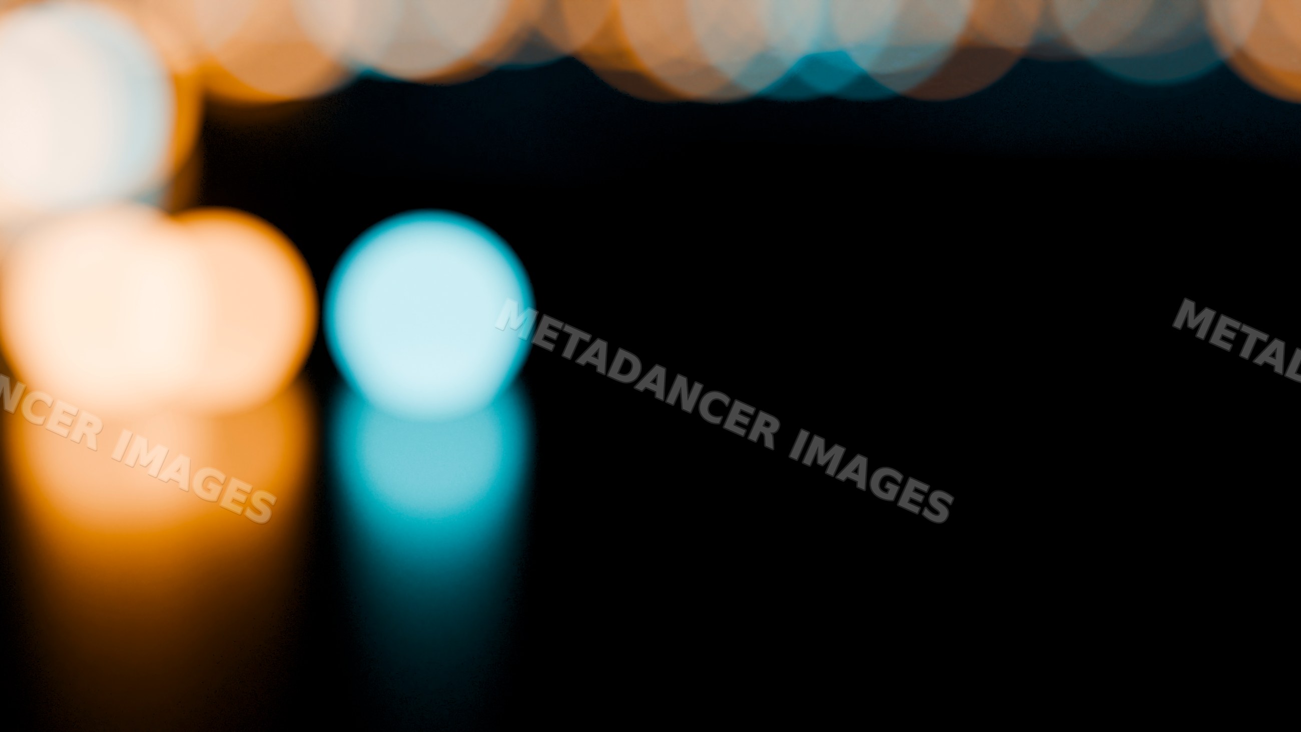 Colorful blurred lights with bokeh effect on dark background