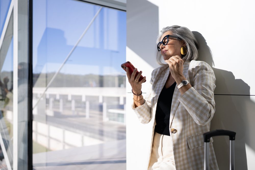Middle-aged white woman checking smartphone