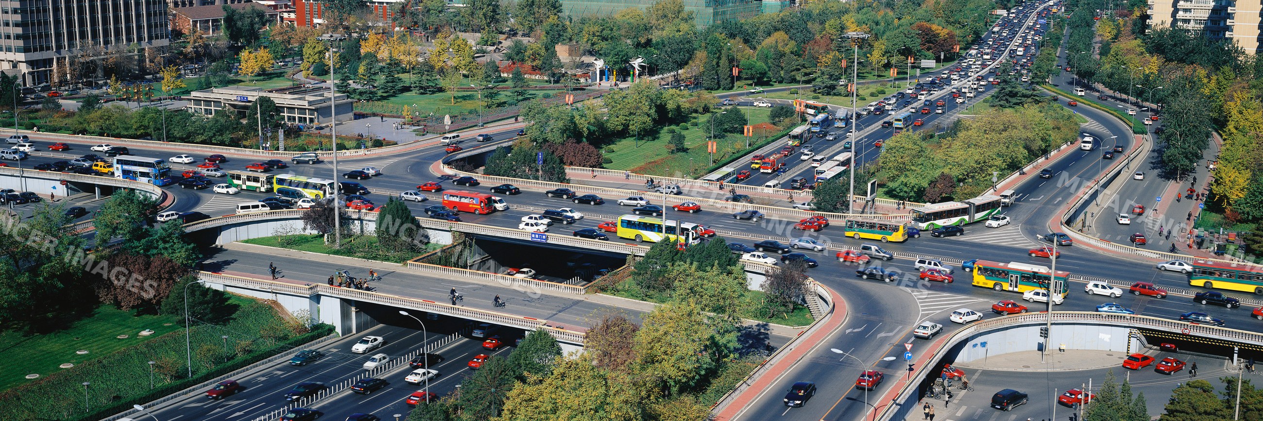 Urban overpasses and busy roads with car and bus traffic adjacent
