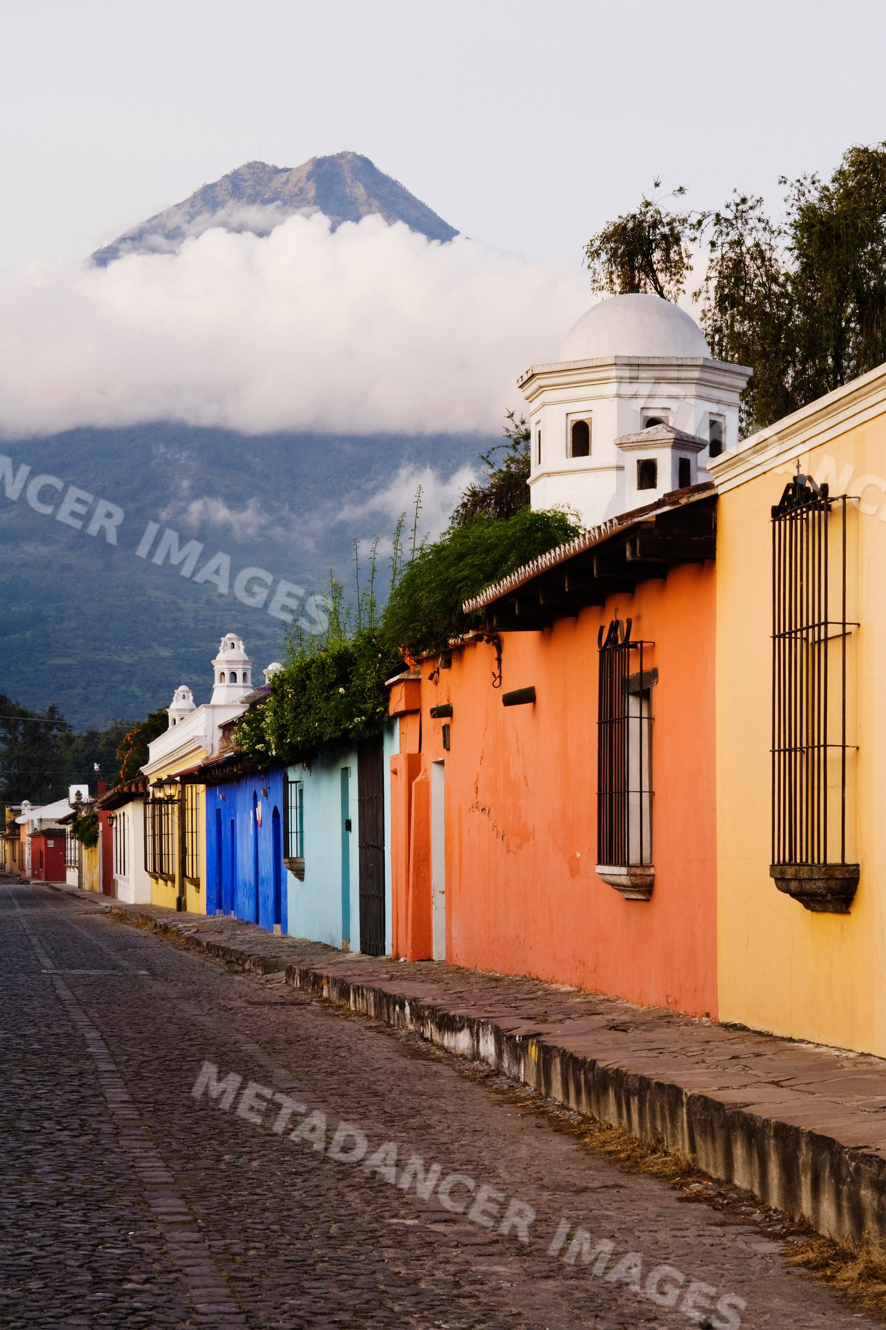 Agua volcano with colorful colonial buildings, guatemala