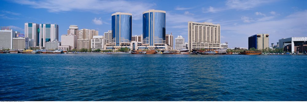 Dubai creek waterfront featuring modern buildings and boats