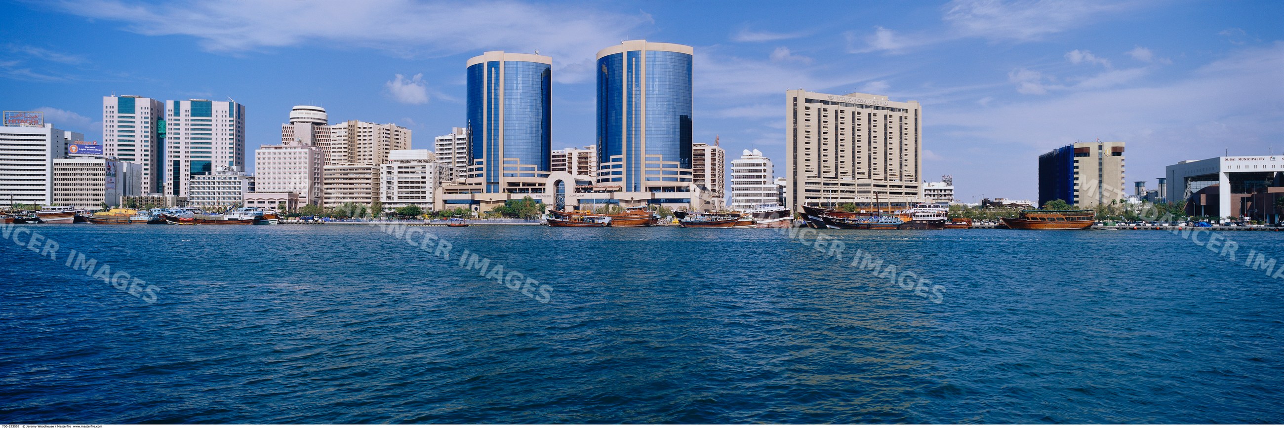 Dubai creek waterfront featuring modern buildings and boats