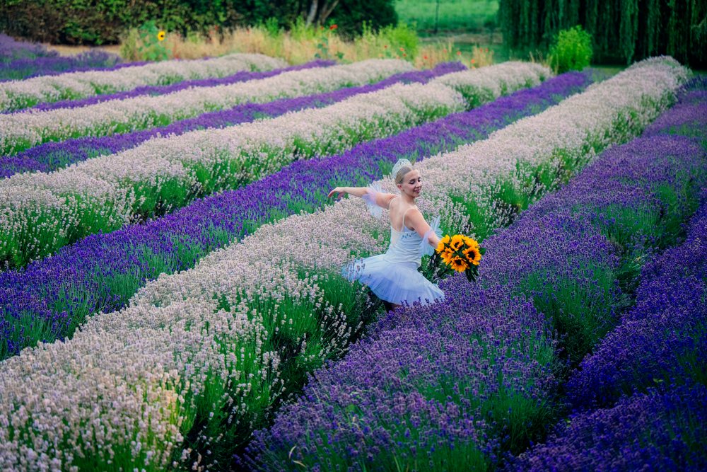 A ballet white dancer with a sunflower bouquet dances