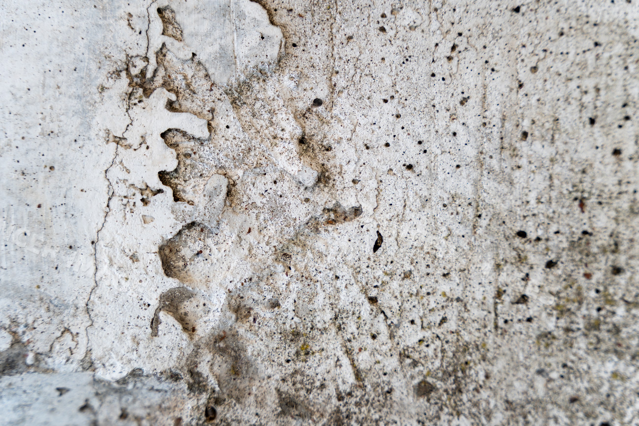 Weathered rough concrete texture background with cracks and blemishes