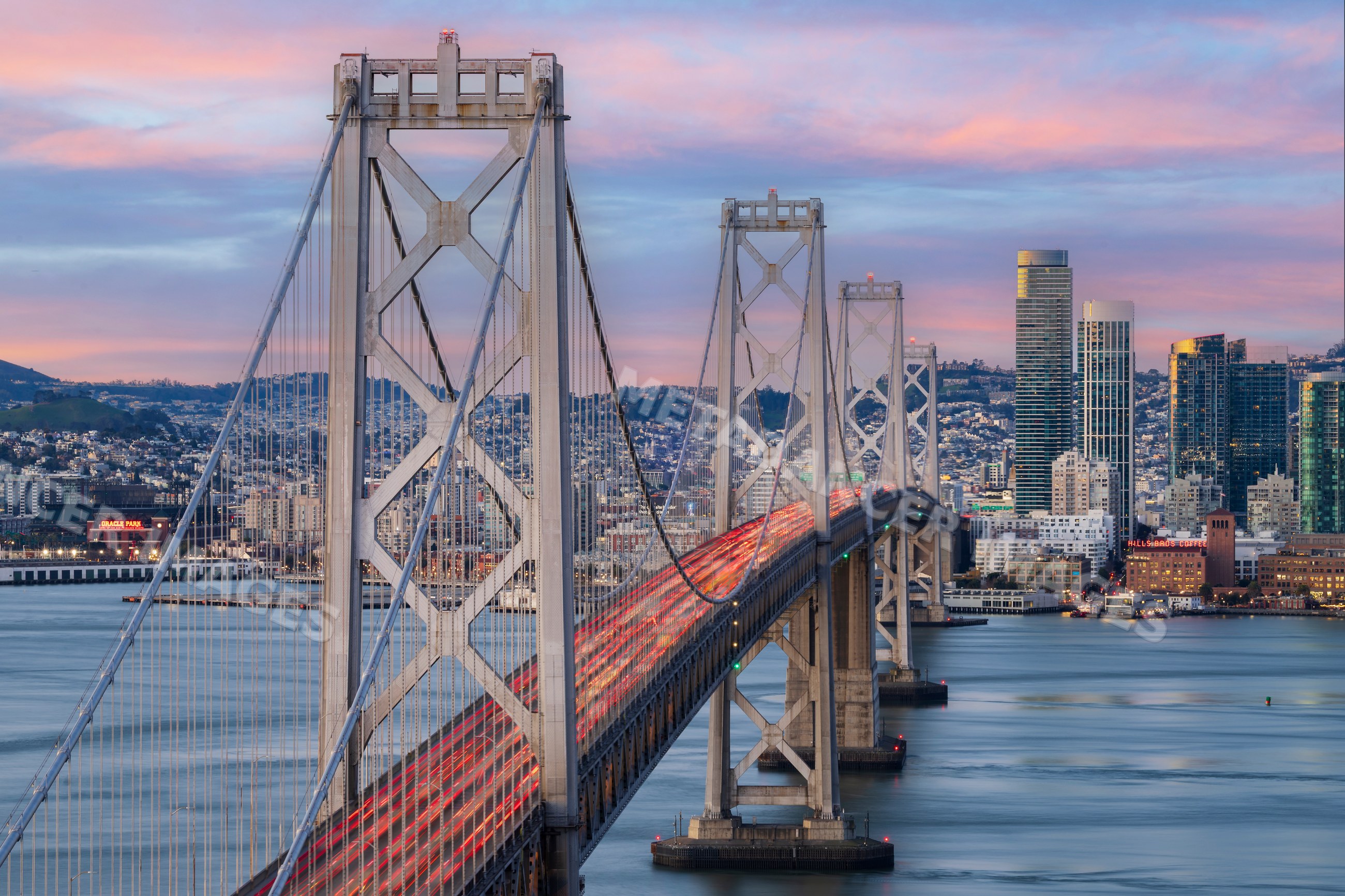 Bay Bridge traffic at Sunrise with San Francisco city skyline