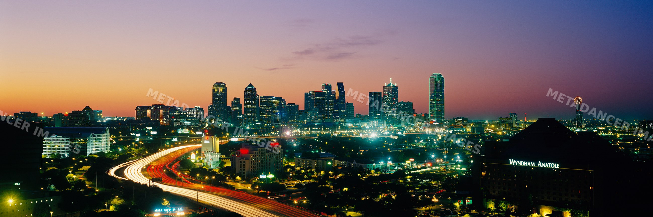 City skyline of dallas, texas at sunset with illuminated buildings