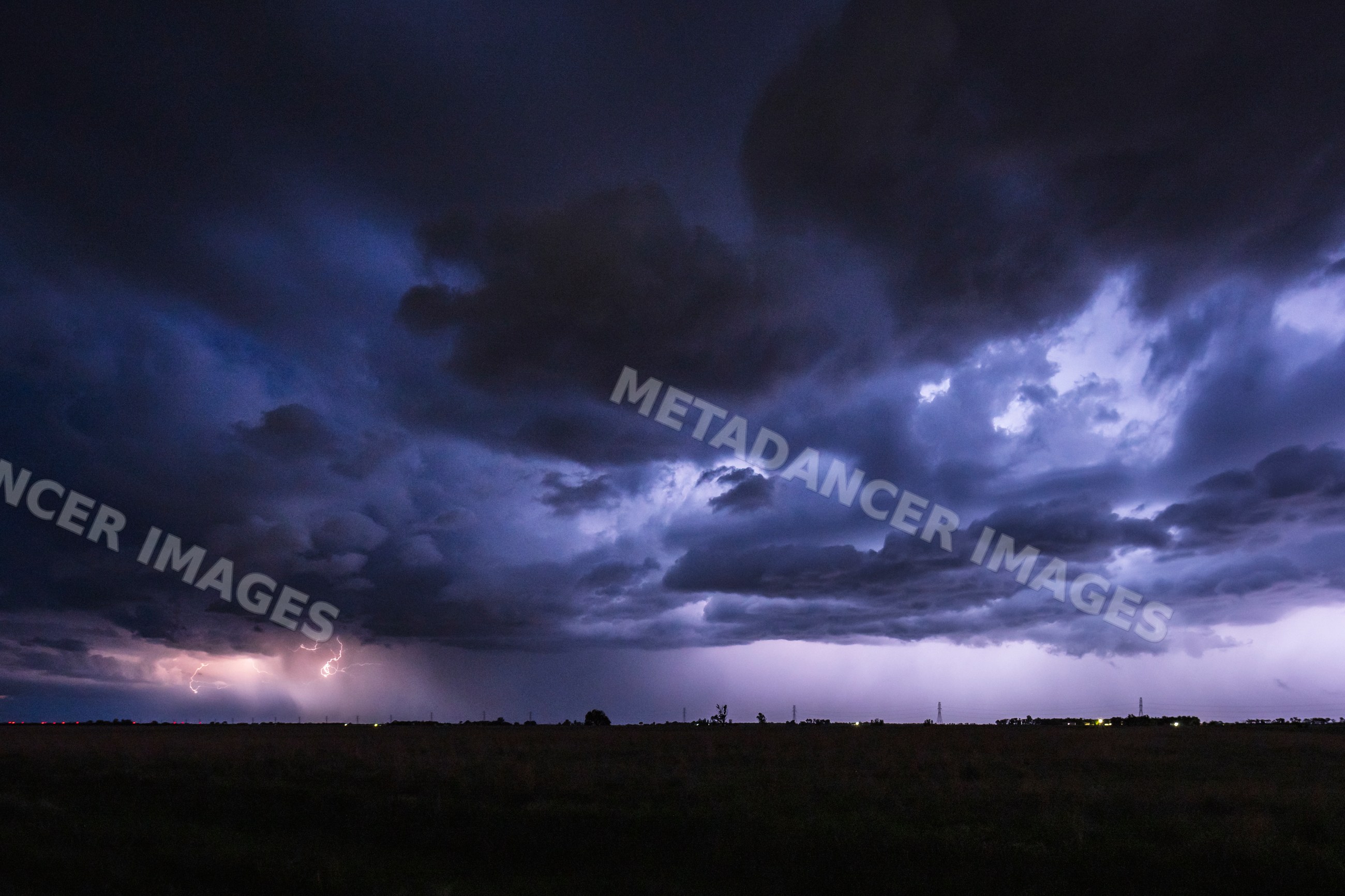 Storm clouds with lightning over rural landscape near mitchell