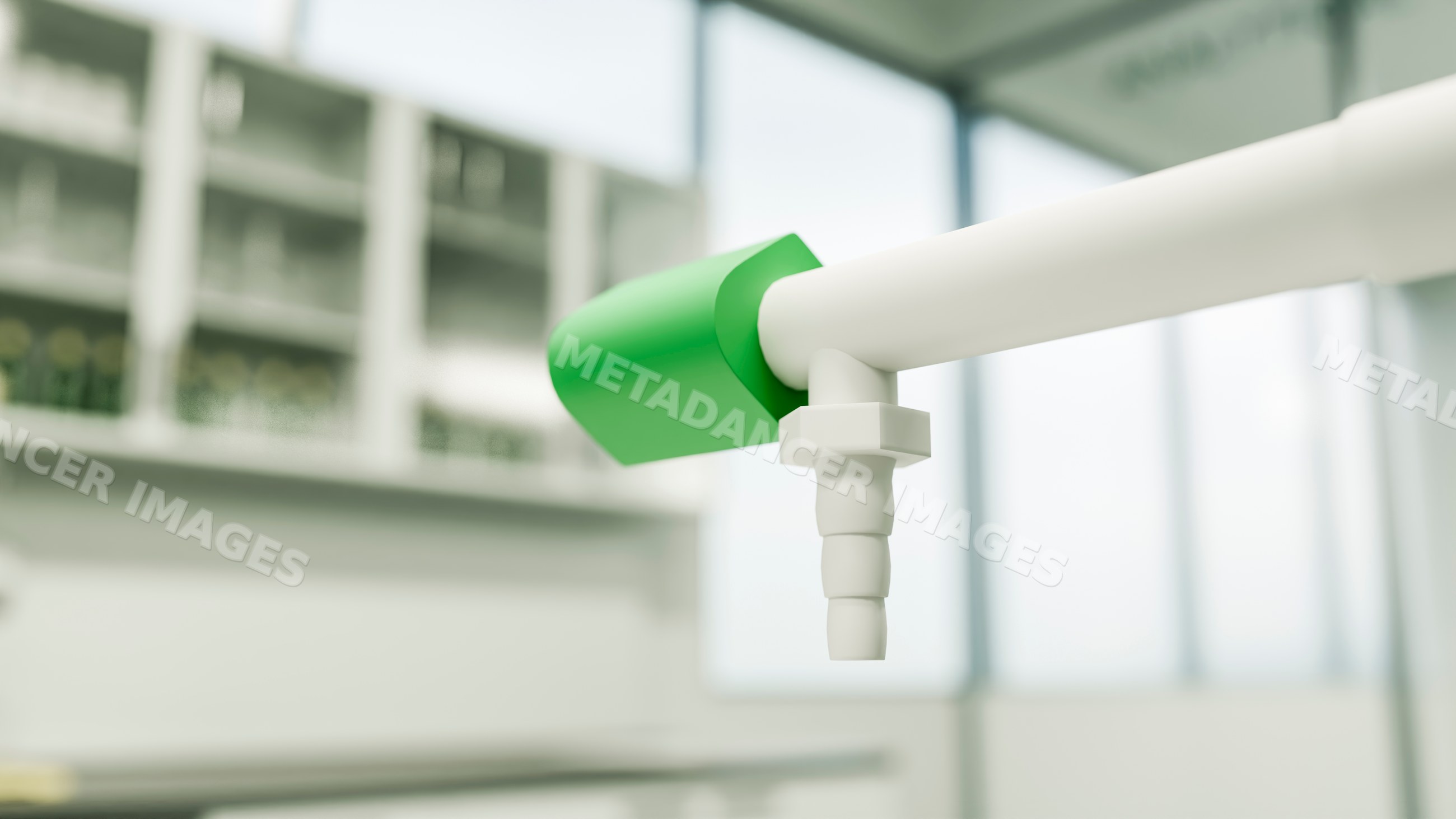 Green valve attached to white pipe fixture in laboratory