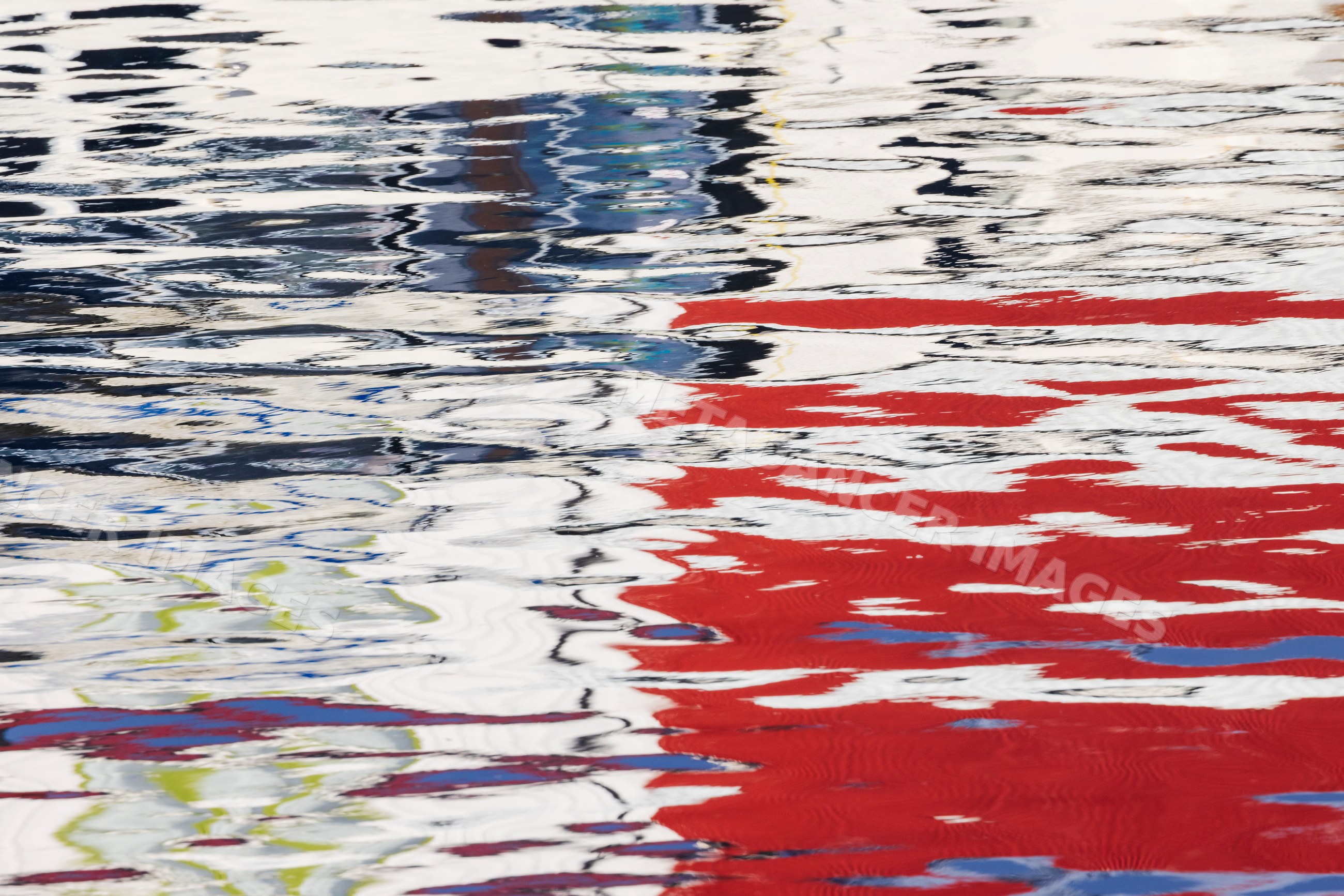 Colorful rippling Reflections on water surface in harbour