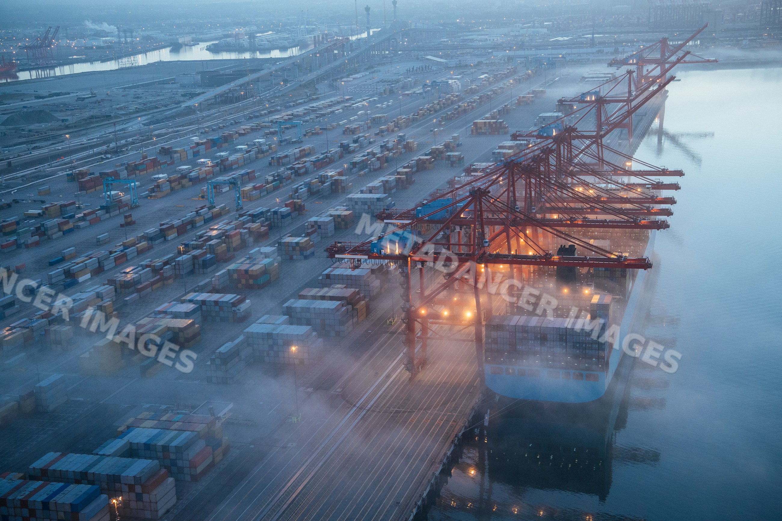 Cargo ship being loaded with containers at a port in Long Beach, CA, USA