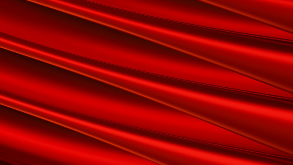Red silk fabric with smooth folds and shiny texture
