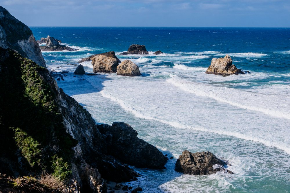 Rocky coastline with ocean waves along California coast