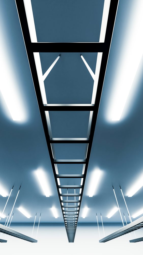 Metal ladder hanging from ceiling with fluorescent lights