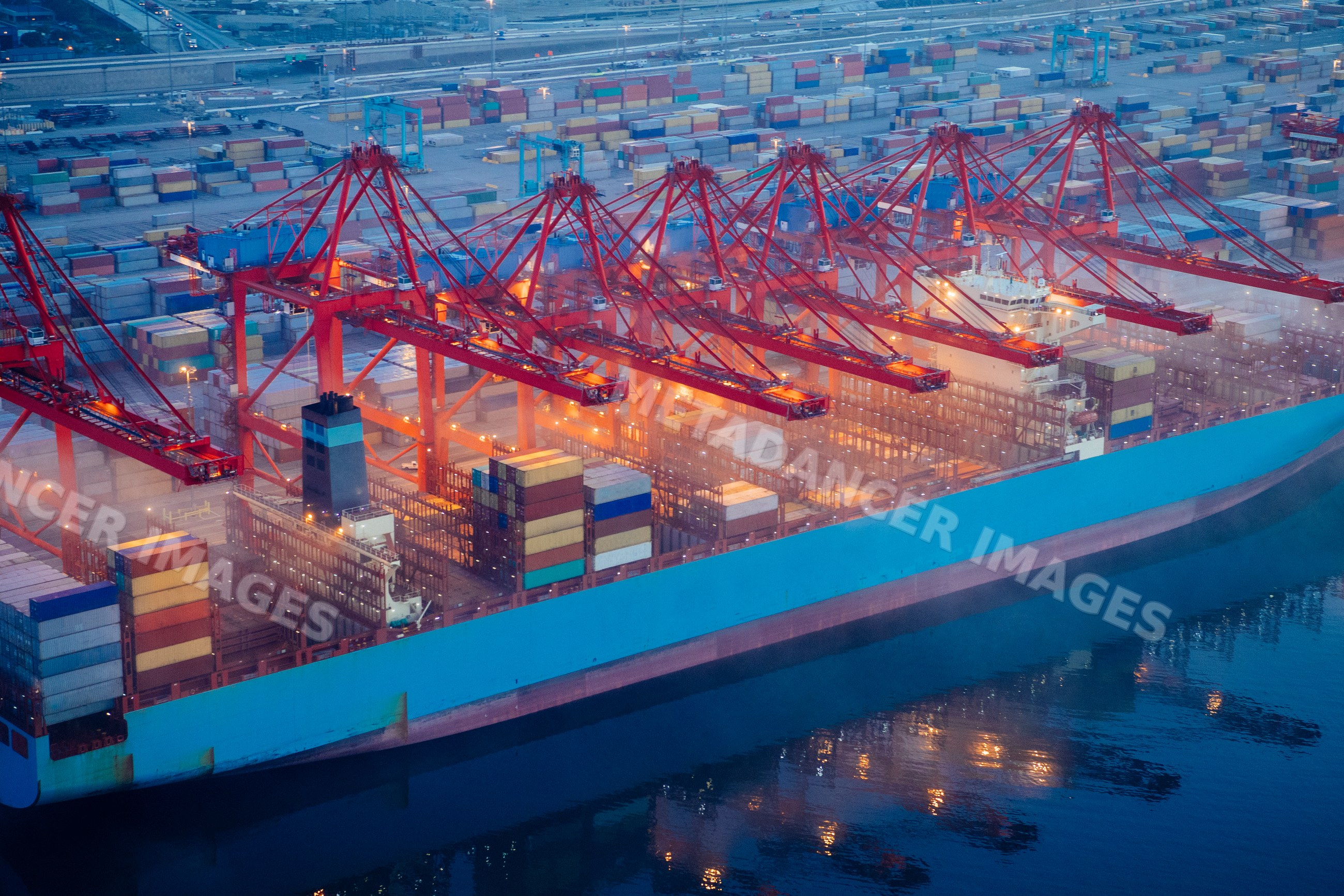 A container ship is loaded with cargo containers