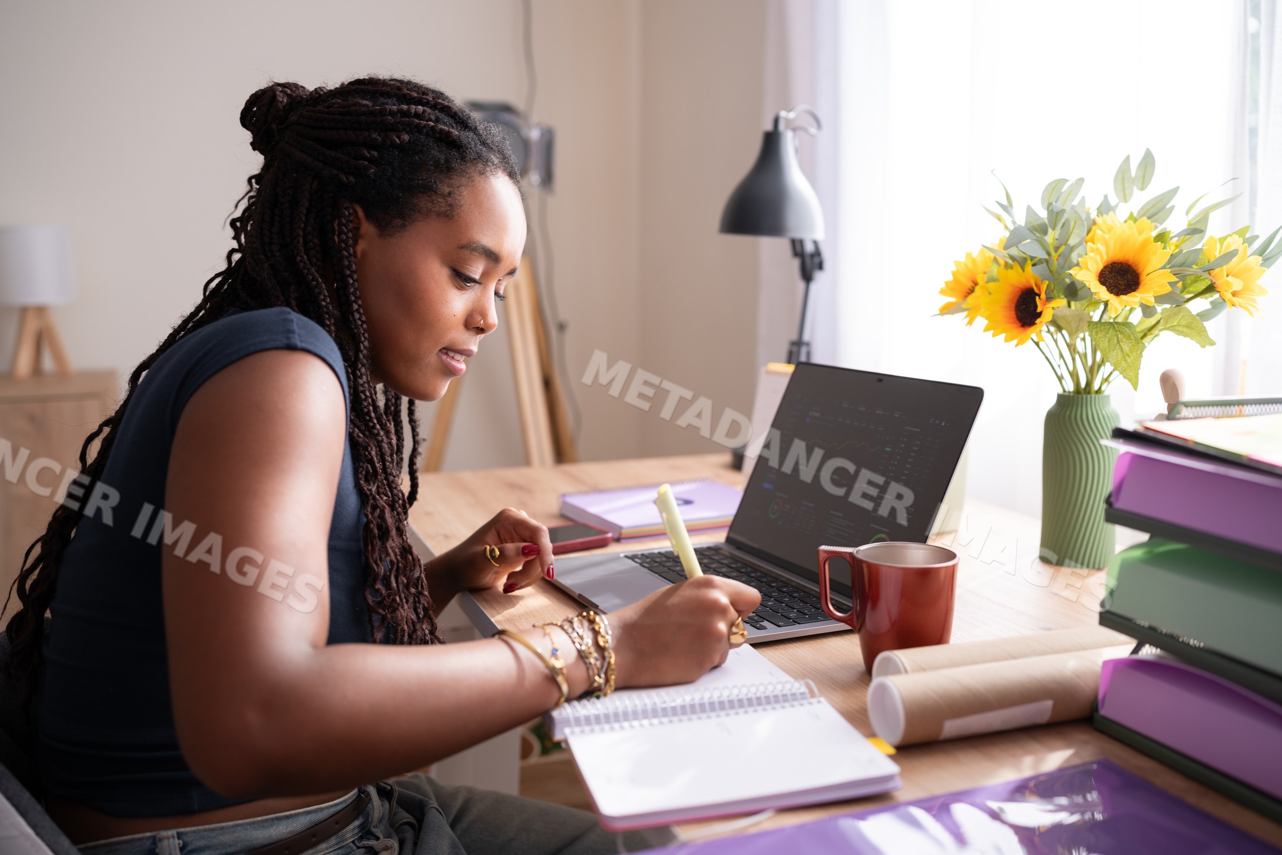 Young African American woman writing notes