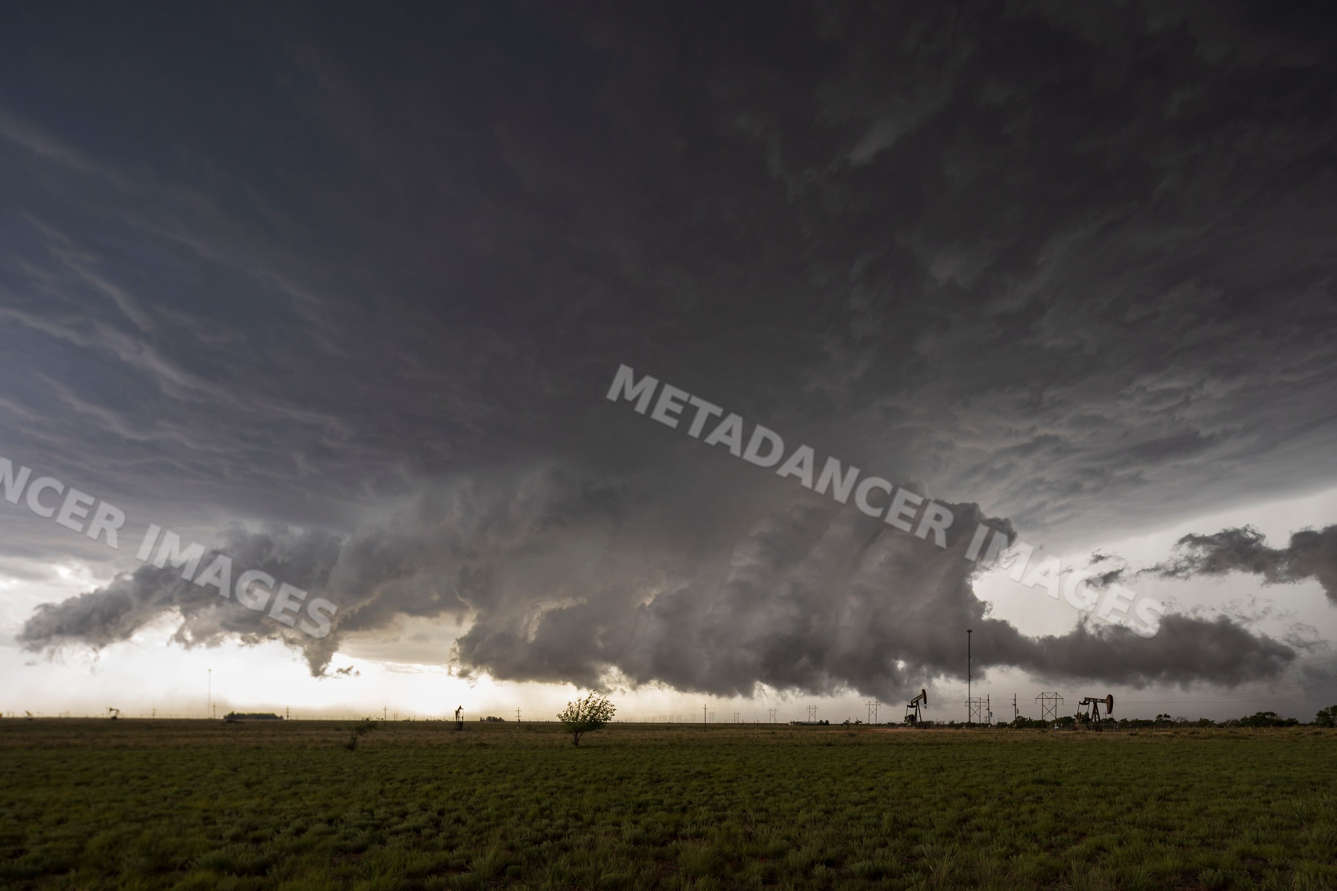 Supercell thunderstorm creating tornadoes over oil field in levelland