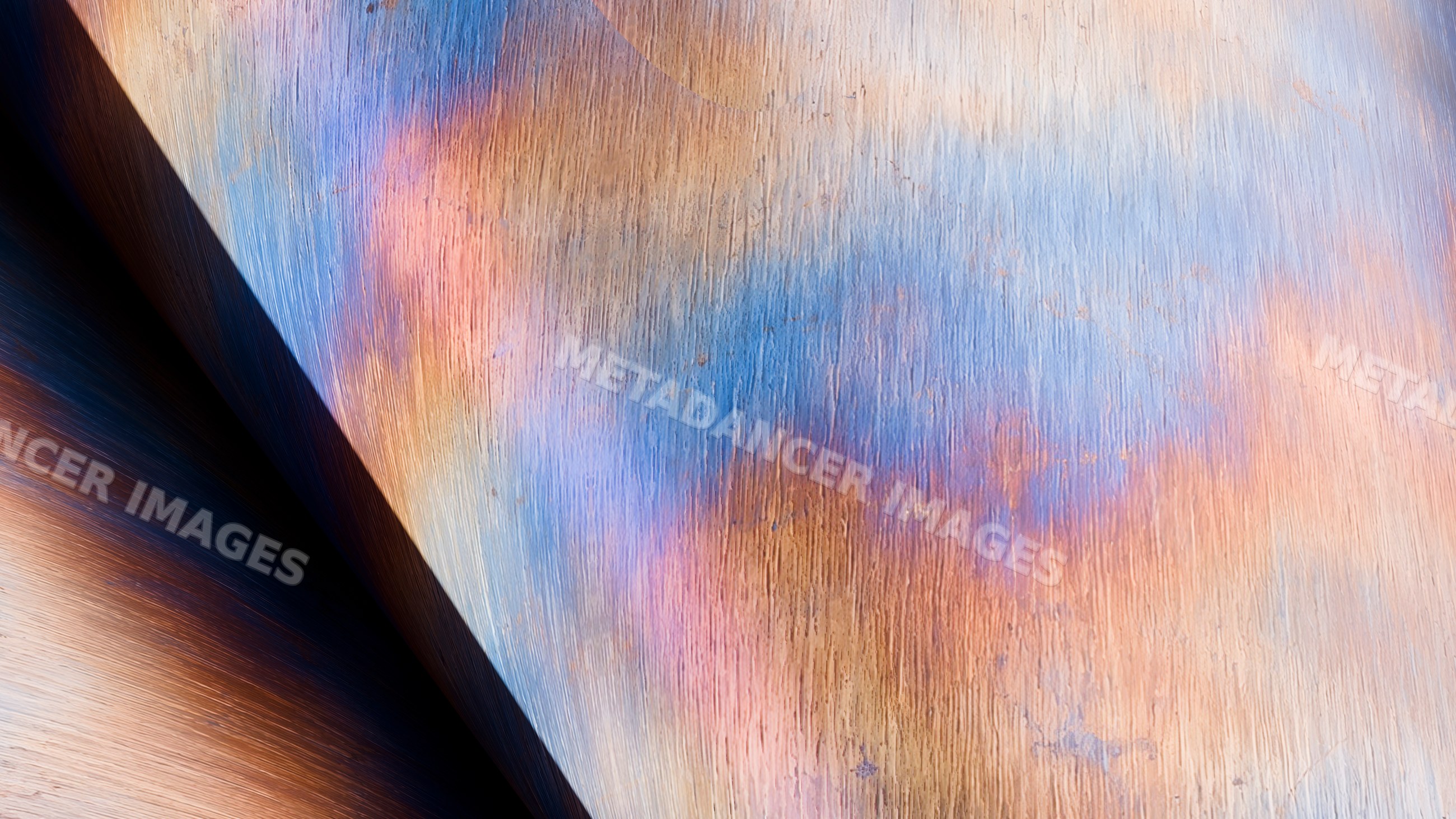 Close-up view of metal surface with colorful oxidation and rust