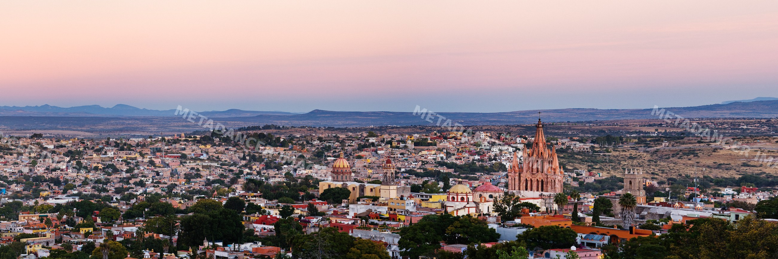 Sunset cityscape of san miguel de allende with colonial church spires