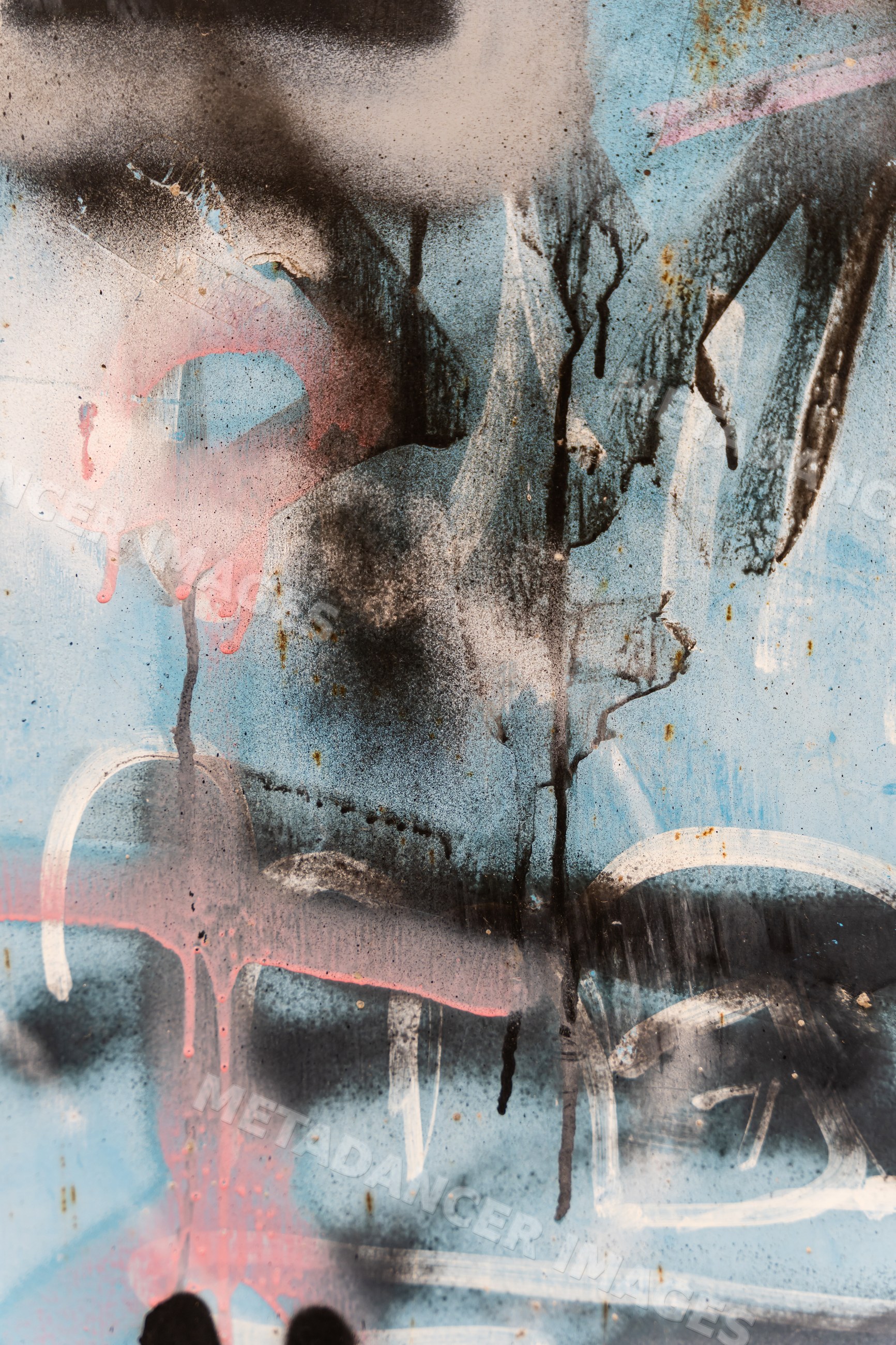 Abstract colorful spray paint texture on weathered blue metal surface