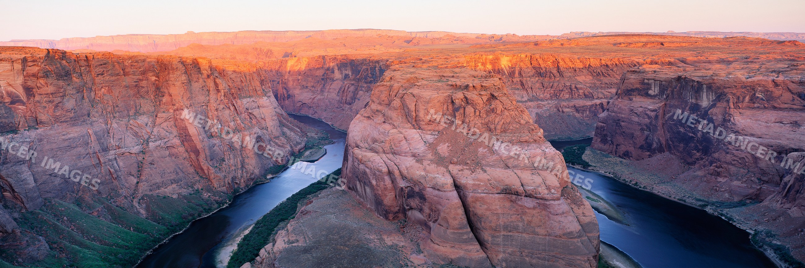 Horseshoe bend colorado river winding through red rock canyon