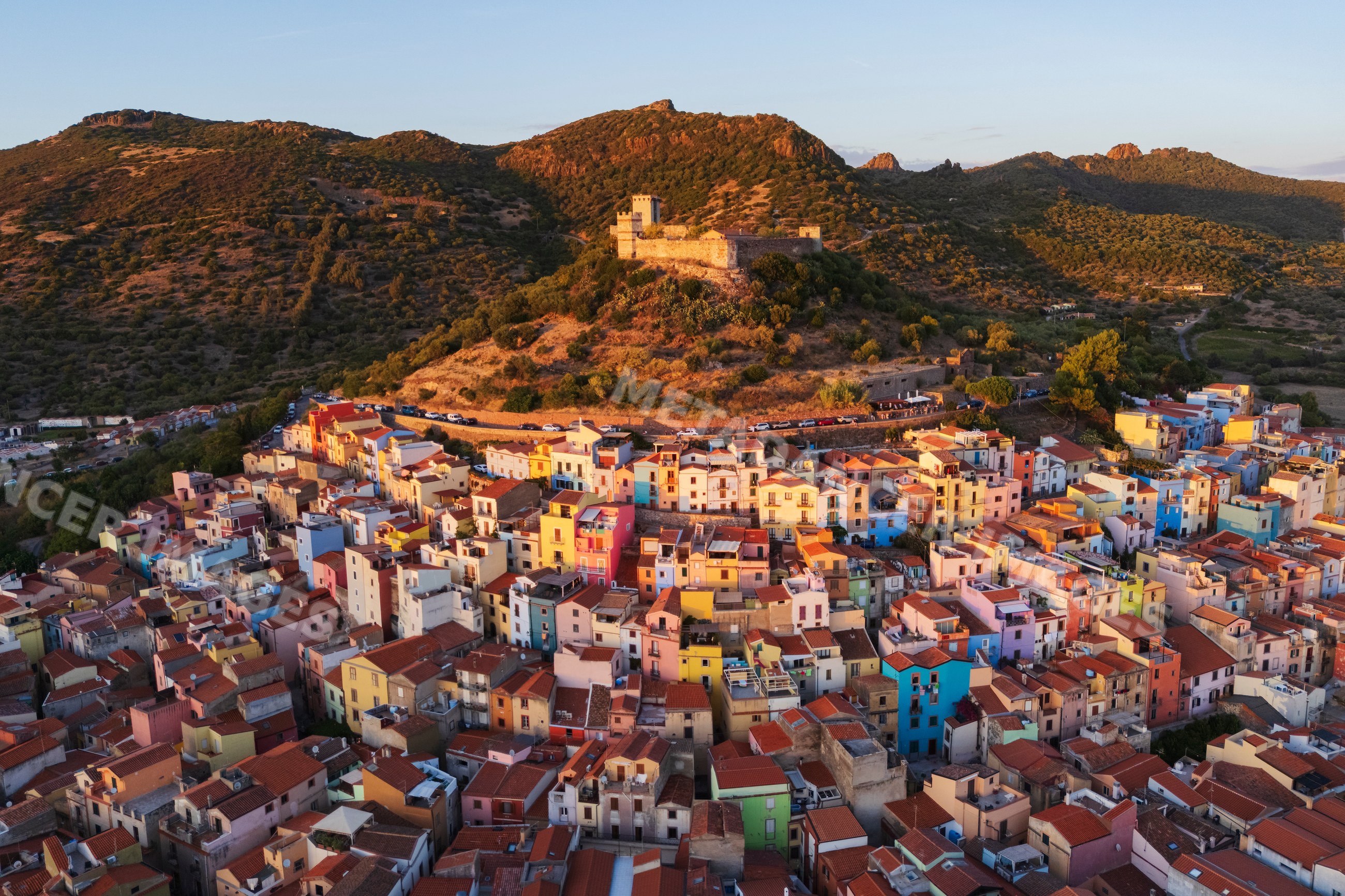 Old town castle and colorful houses at Sunset in bosa Sardinia Italy