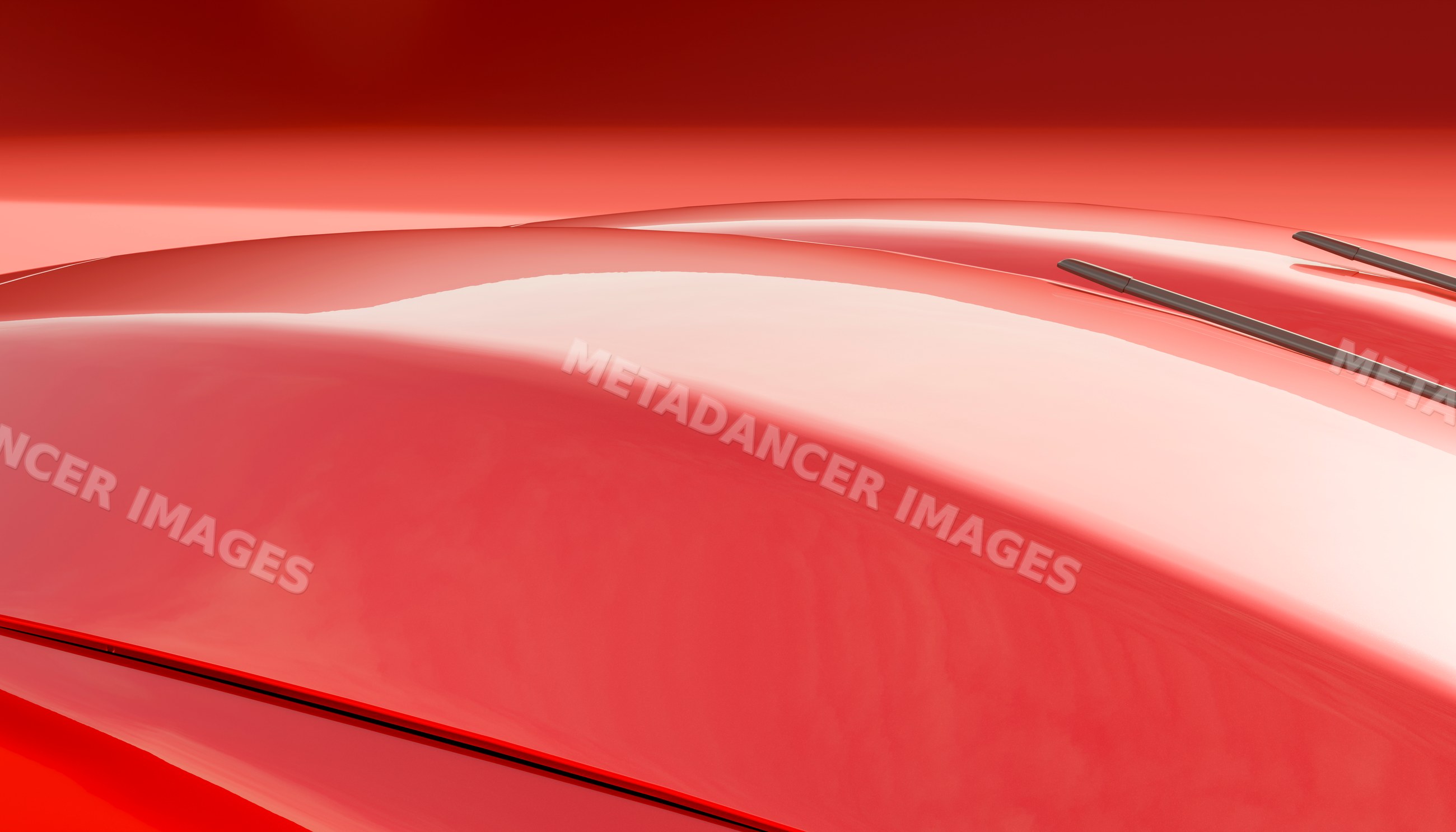 Close-up of a shiny red car hood with windshield wipers and glossy