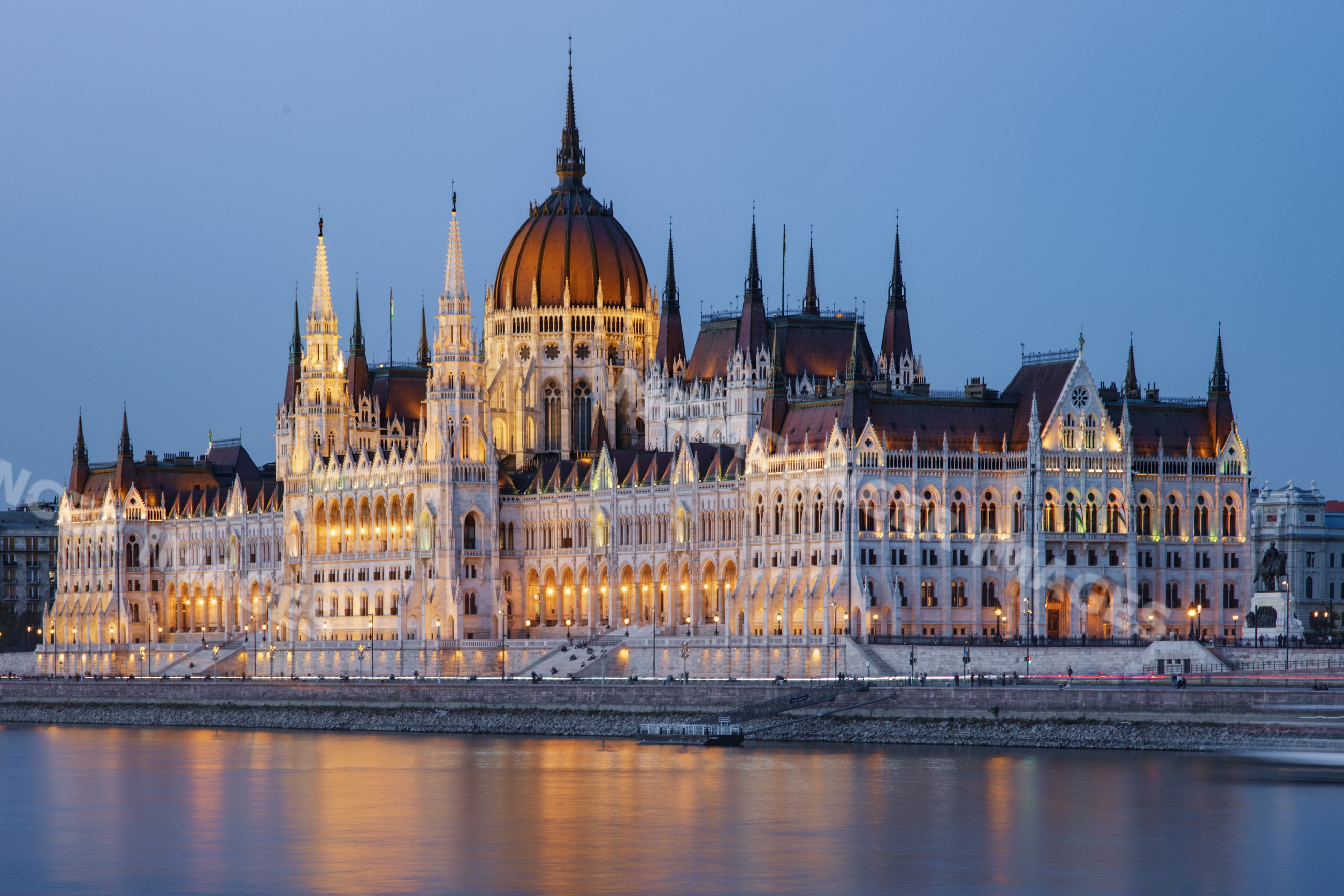 Hungarian Houses of Parliament along Danube River at dusk in budapest