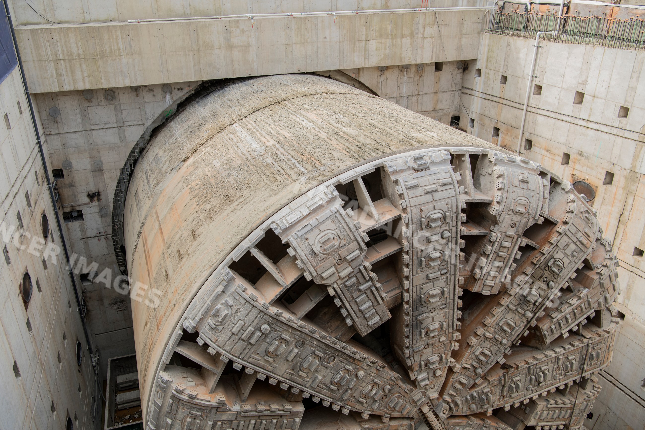 A large tunnel boring machine drills through underground rock