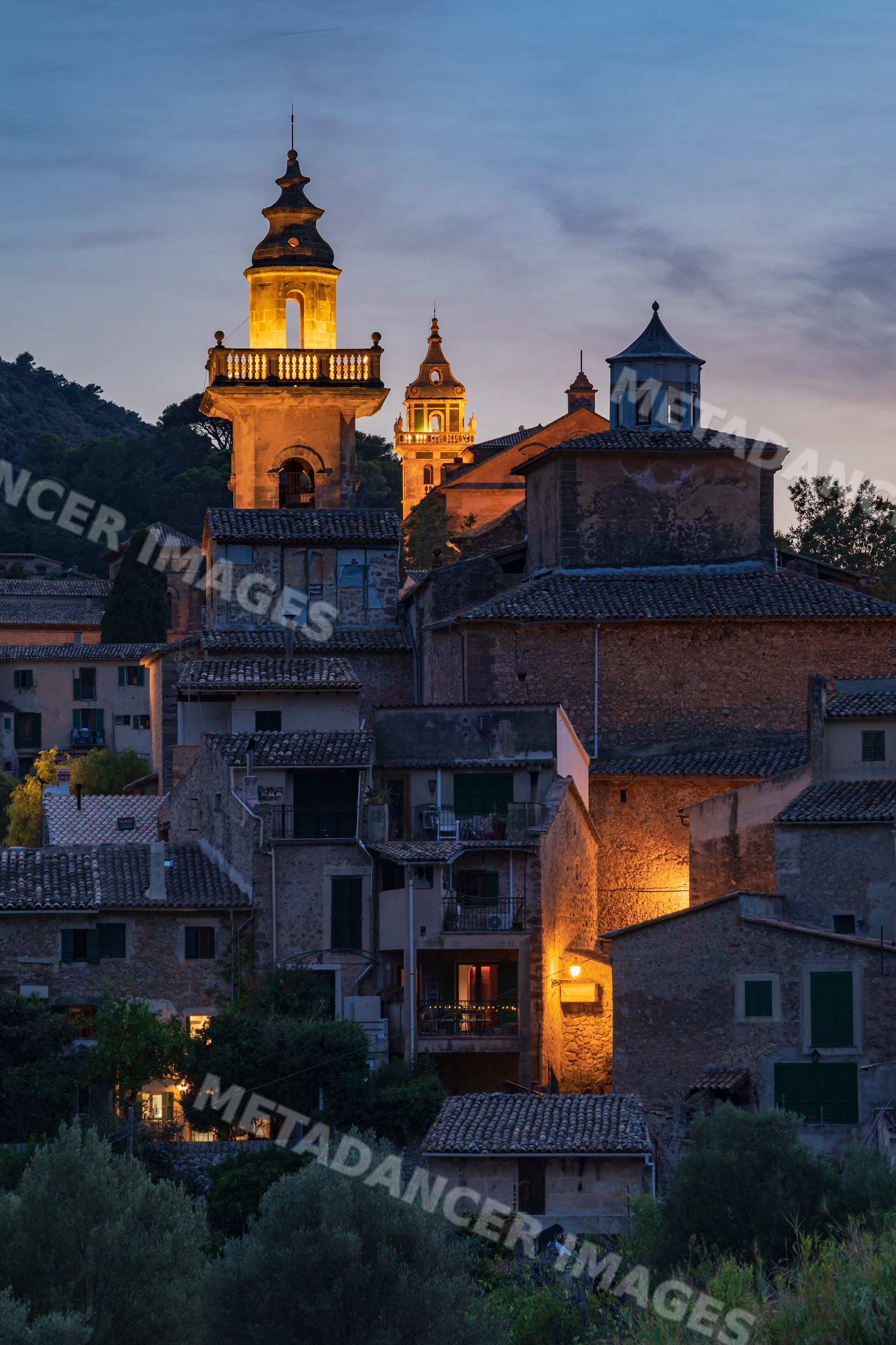 Valdemossa village skyline at dusk with illuminated historic buildings