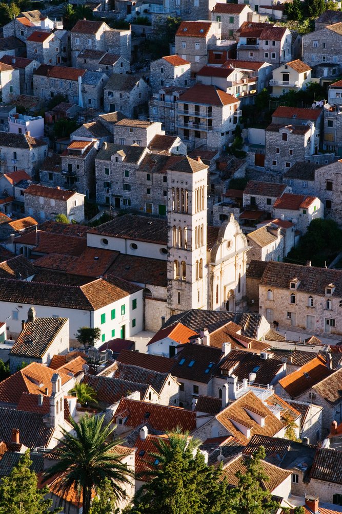 Historic town of hvar with stone houses and church bell tower