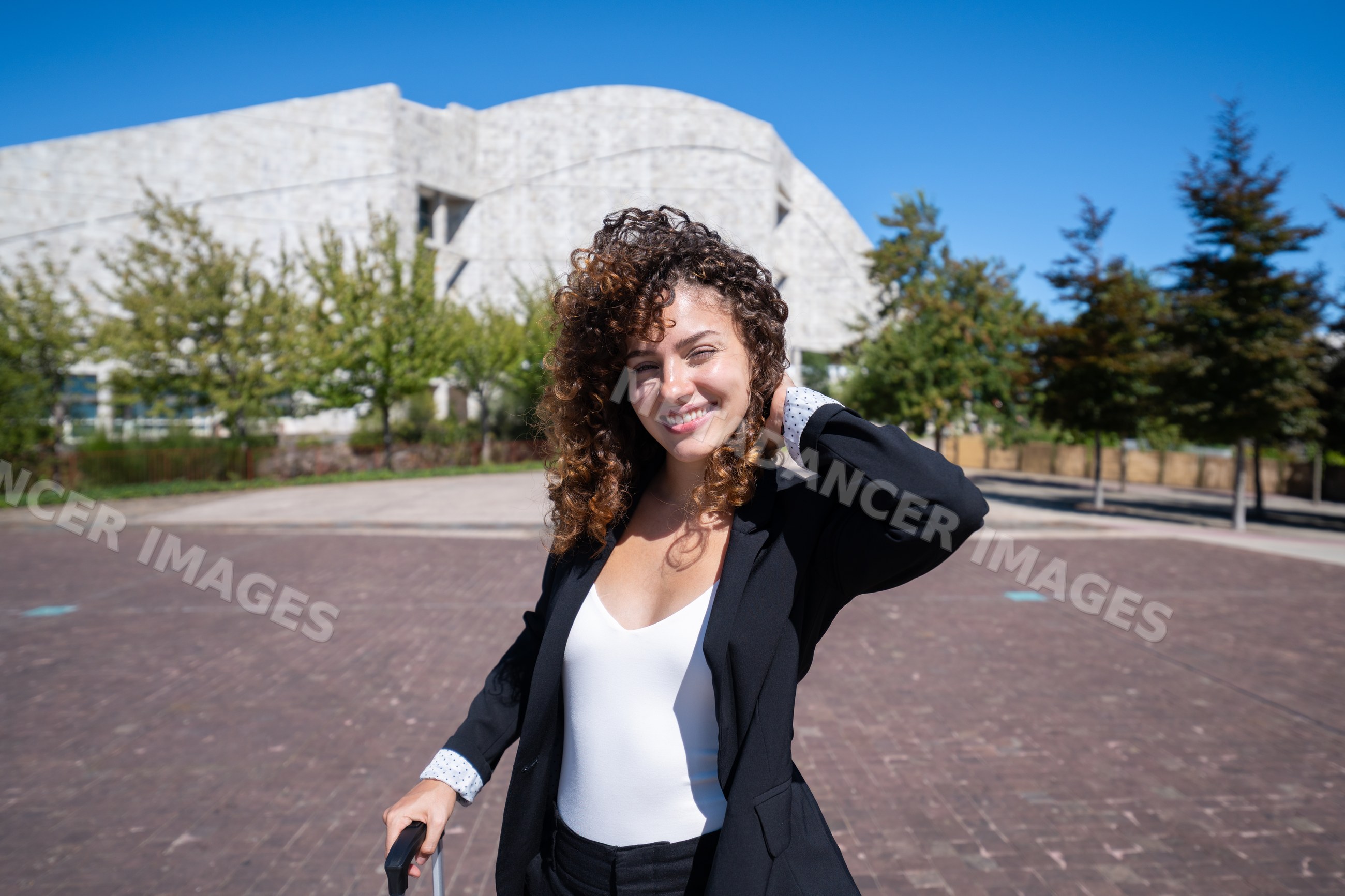 Businesswoman posing outdoors near modern building