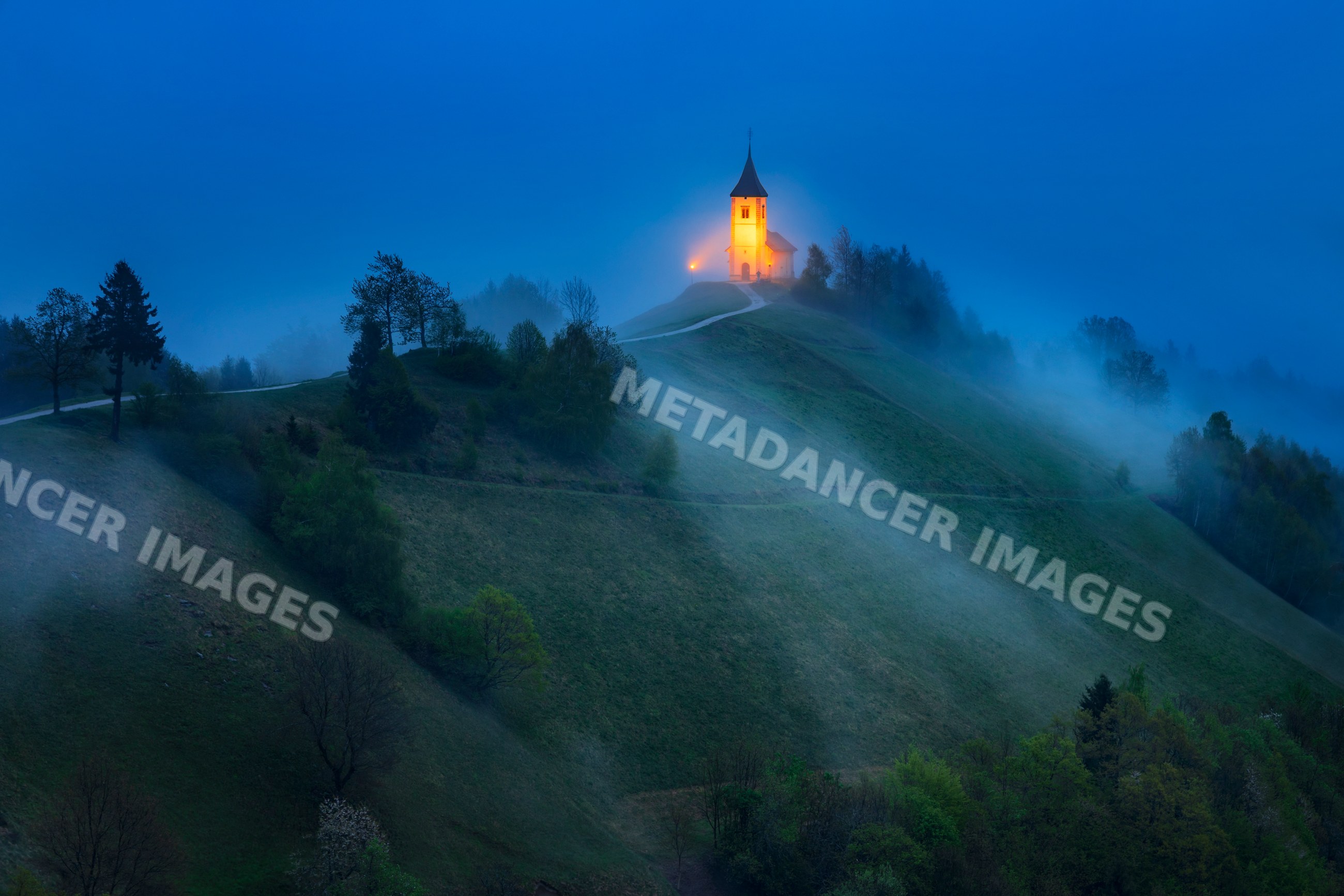 Church of primus and felician glowing on jelovica plateau hill