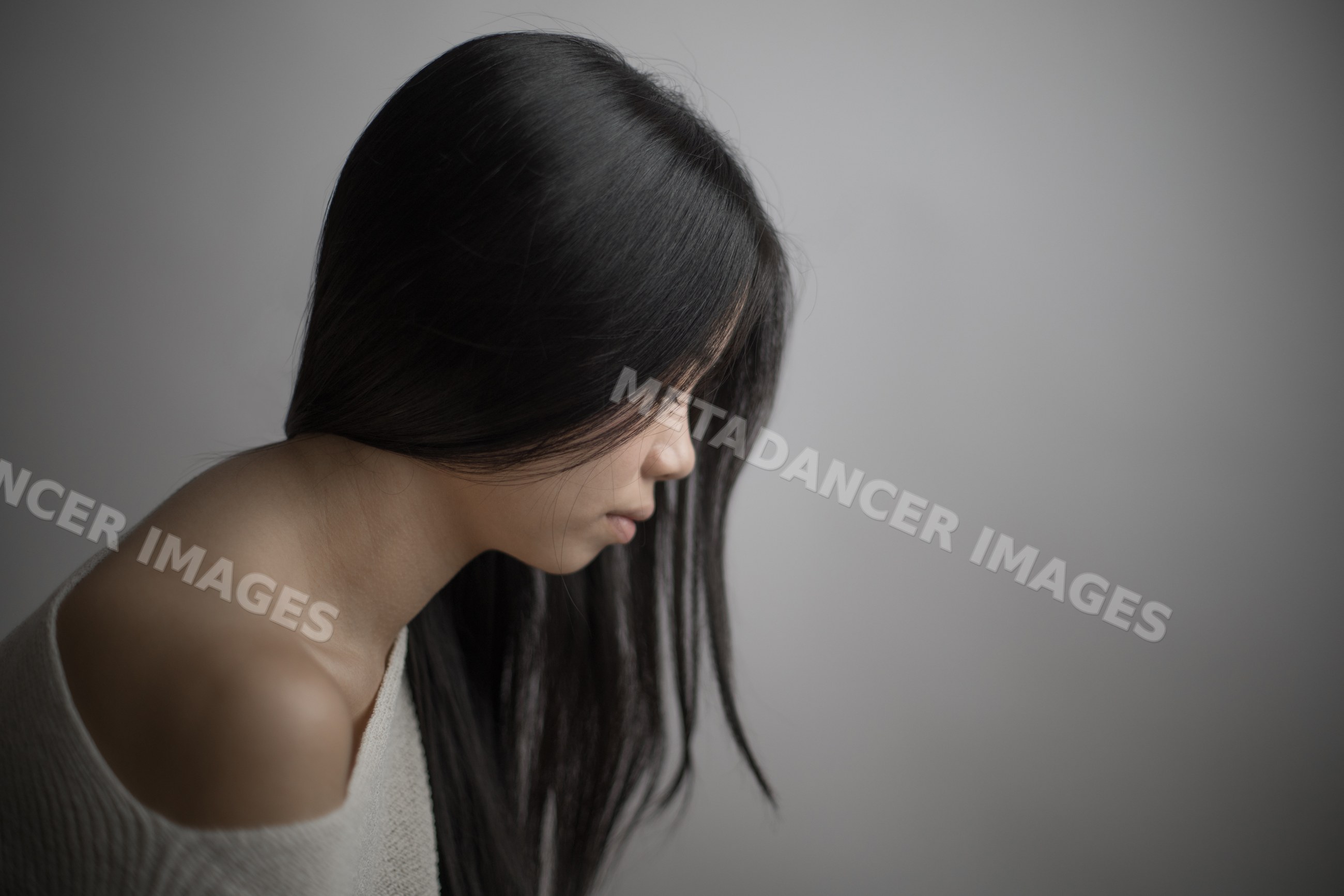 Emotional portrait of a contemplative Southeast Asian woman
