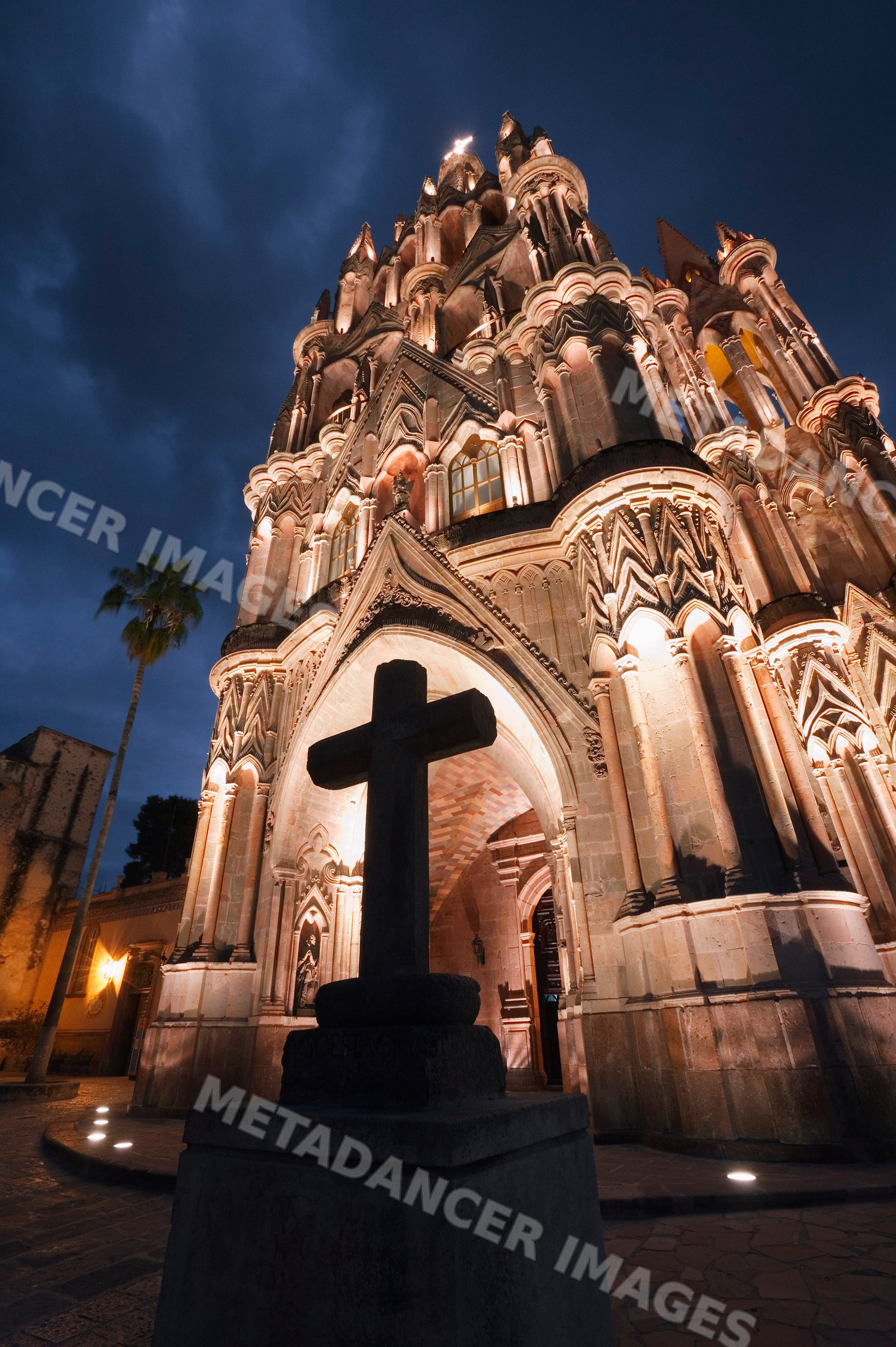 Illuminated gothic stone church with cross mexico
