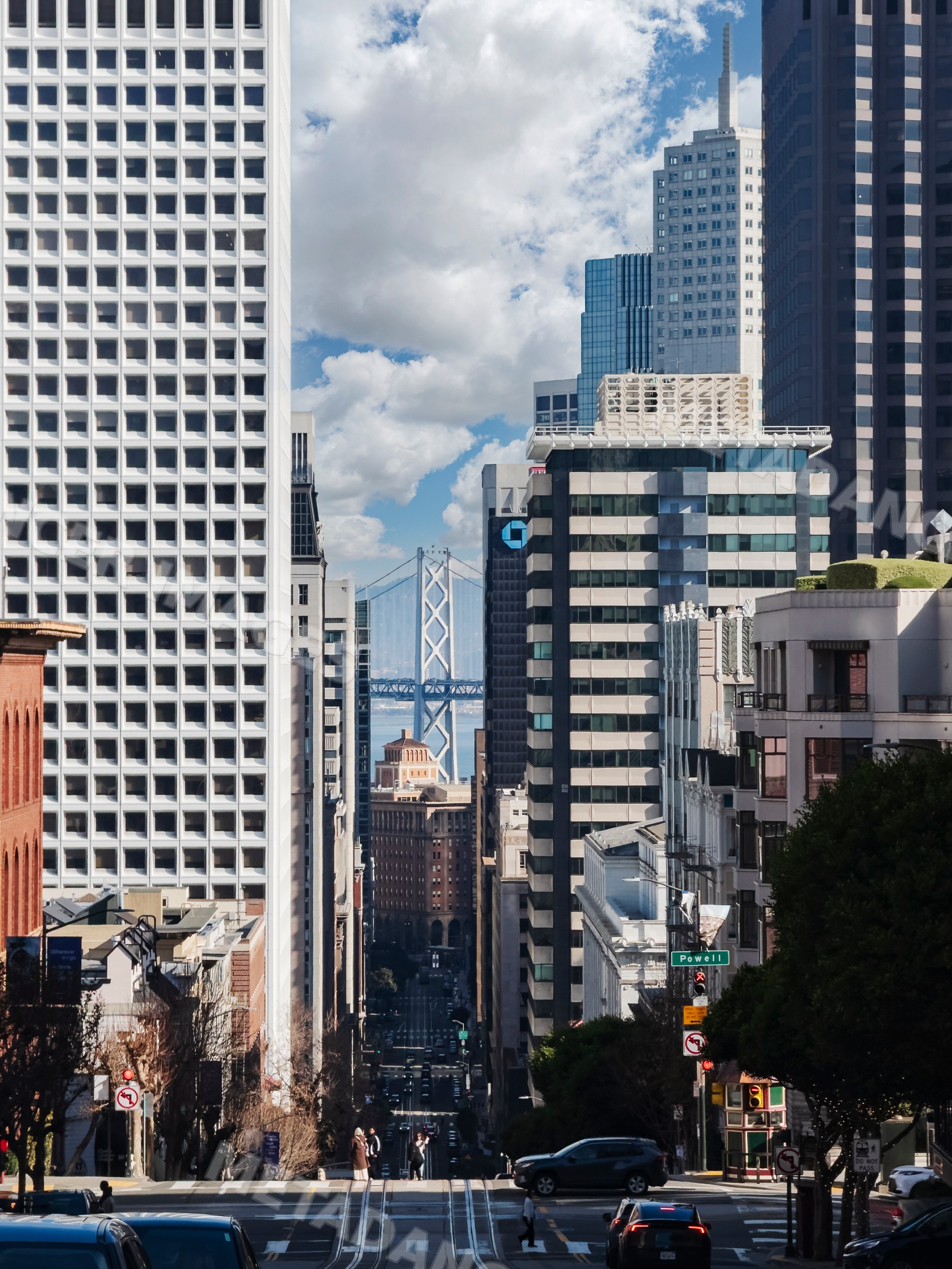 Street in San Francisco with view of bay bridge and city buildings