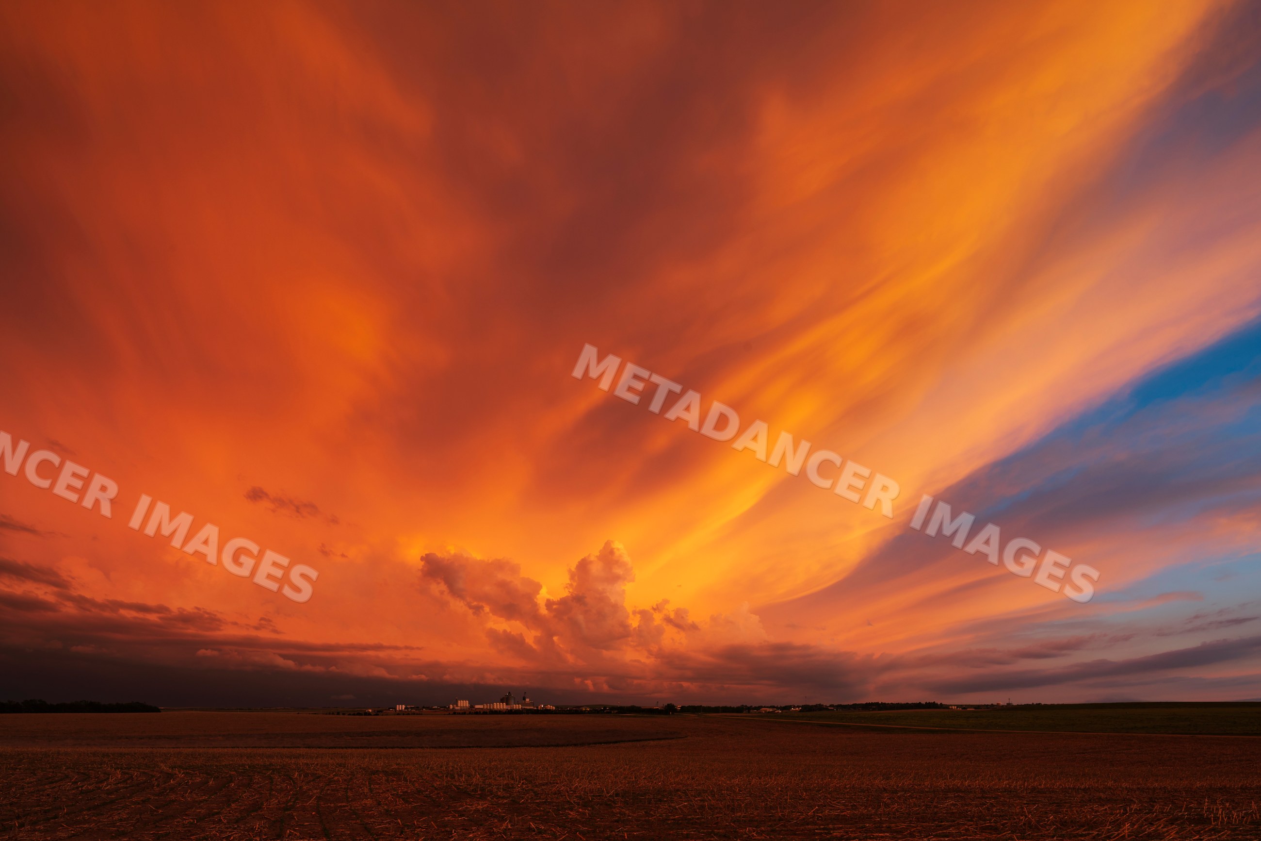 Sunset sky with dramatic orange clouds over rural Winner, south dakota