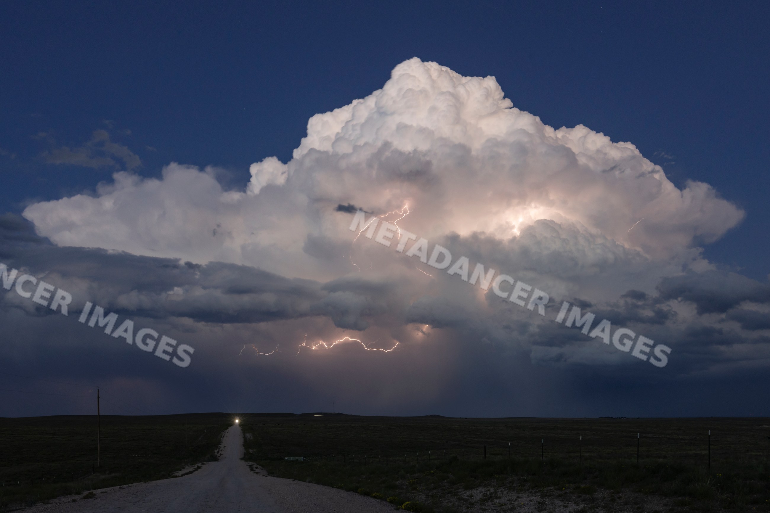 Supercell lightning storm over rural road in nara visa, new mexico