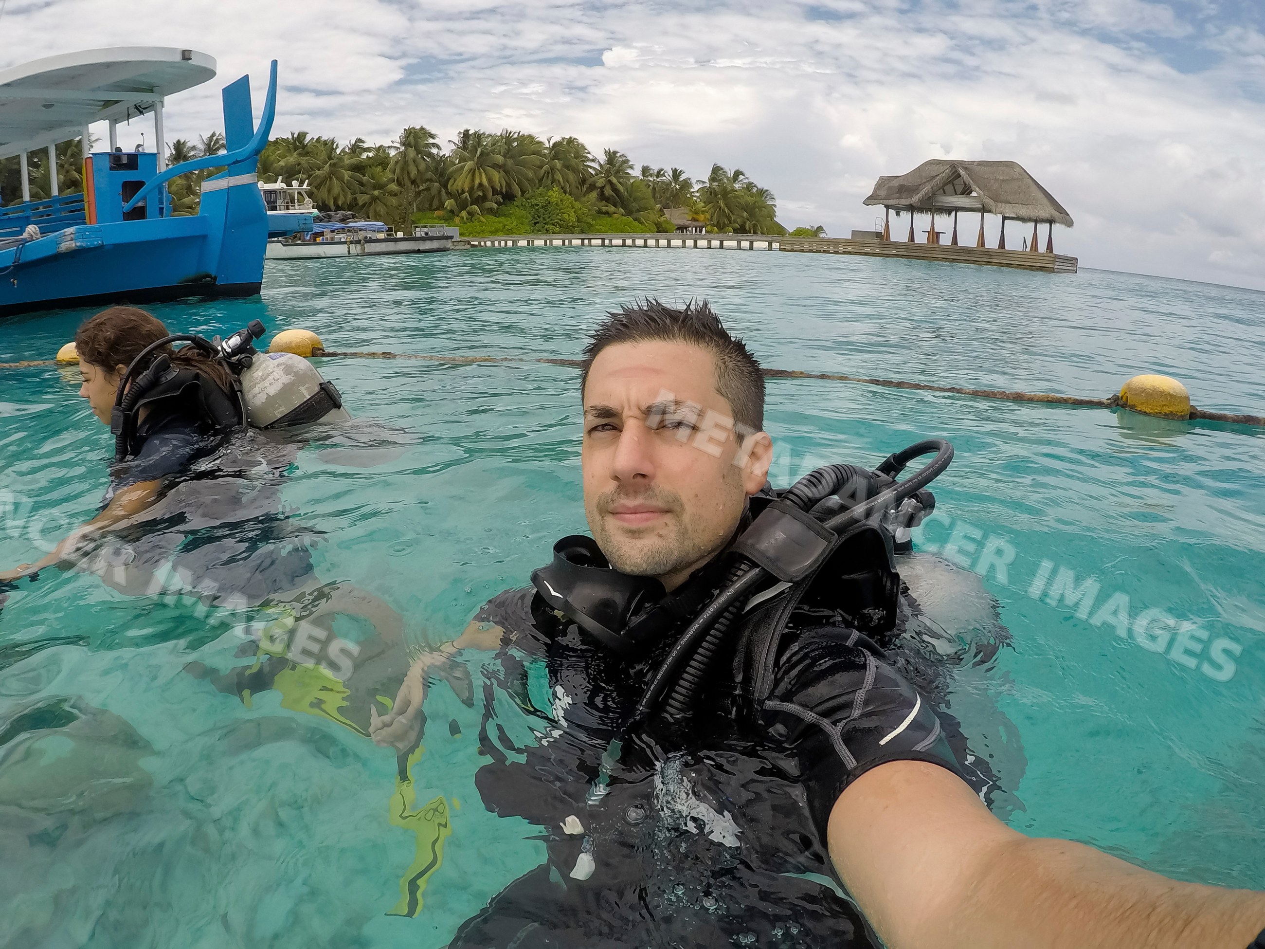 Two scuba divers prepare for a dive