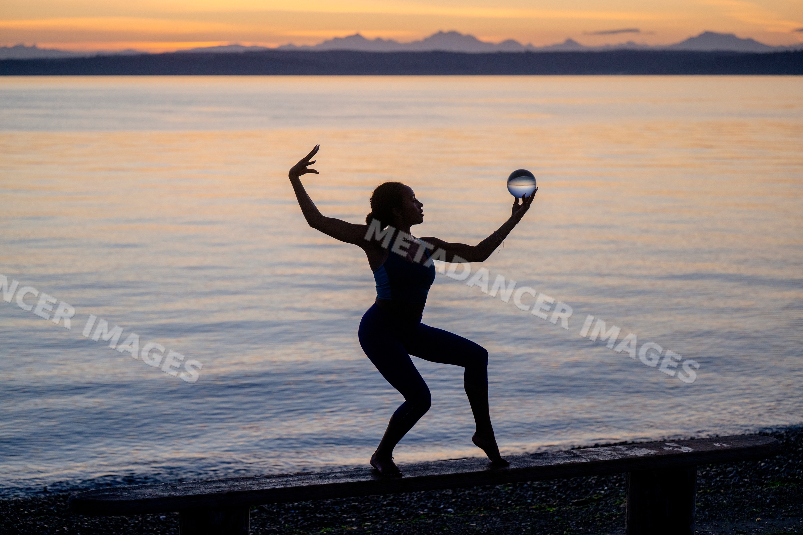 Hispanic woman practicing yoga acrobatics balancing on a bench