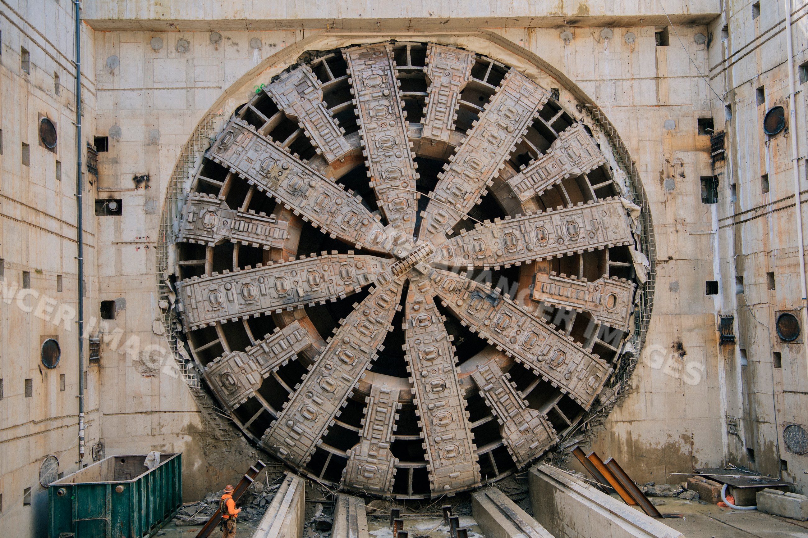 A large tunnel boring machine stands in a construction site