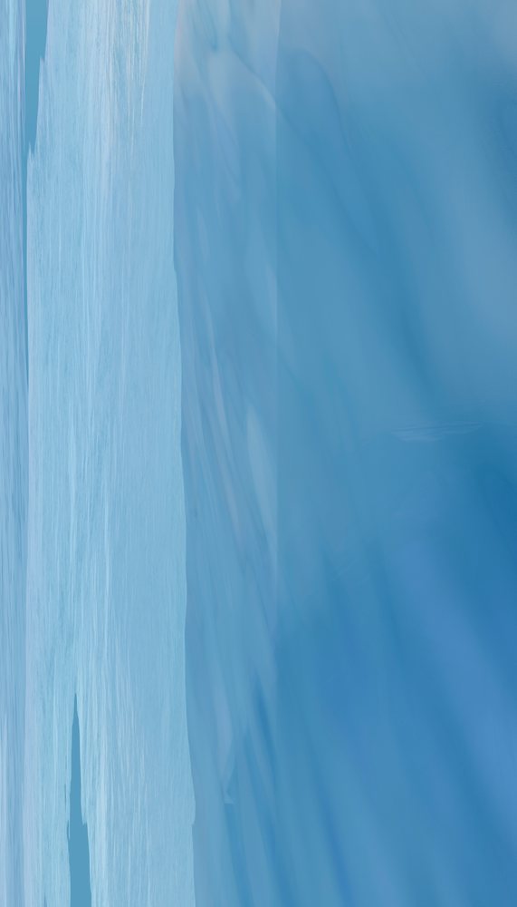 Melting blue iceberg floating in cold ocean water