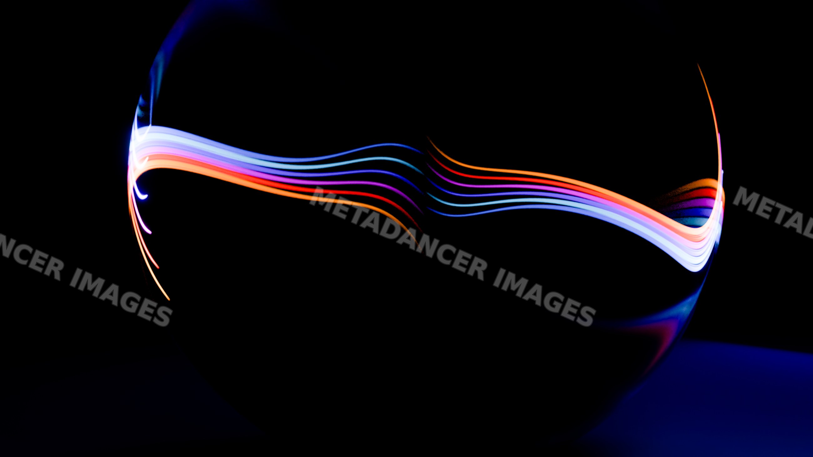 Curved colorful light trails against dark background abstract art